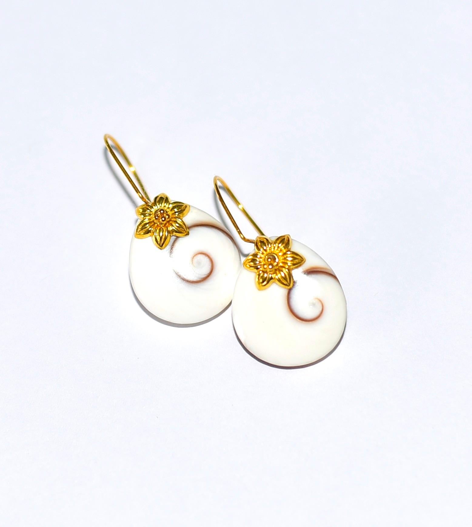 If you want everyday, light, and outstanding accessories, these Shiva Cats Eye earrings are for you! 
What is Shive Cat Eye? Also known as “Pacific Cats Eye” the Shiva Eye Shell comes from a specific type of Snail found off the coast of Thailand. It