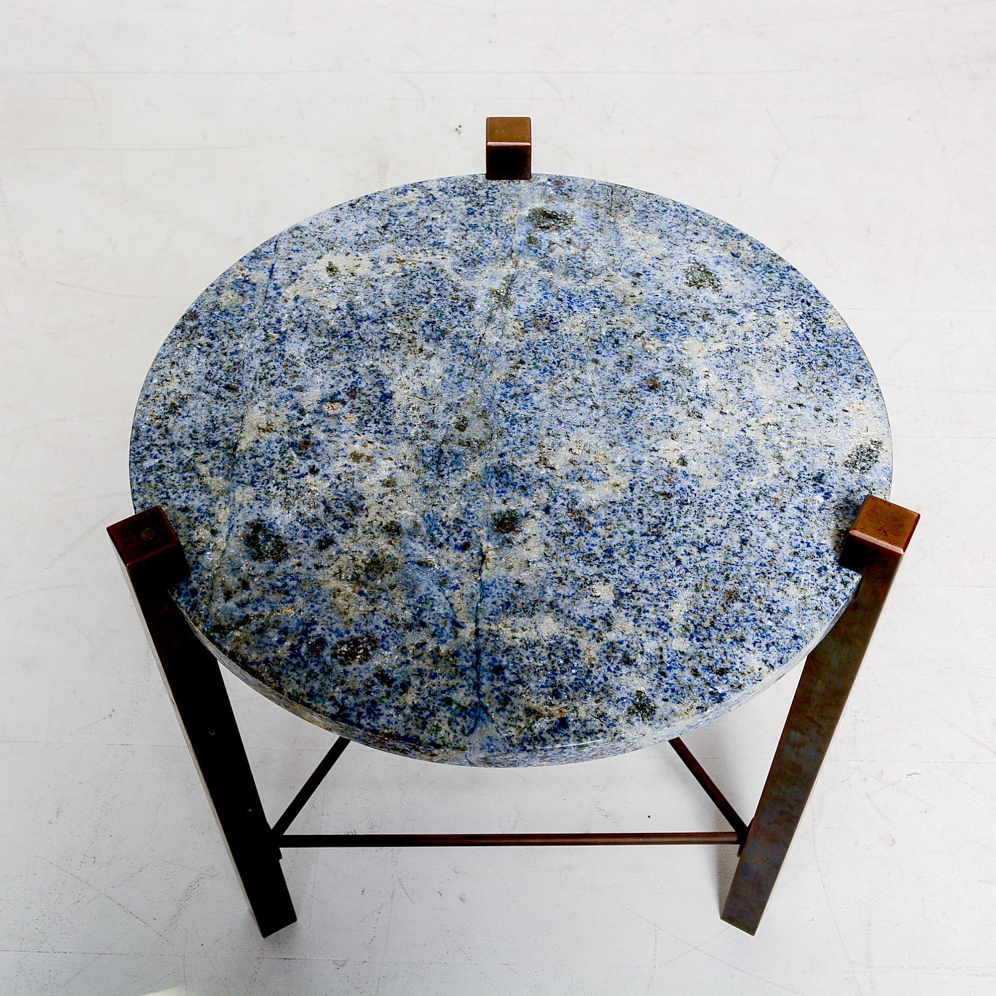 Petite stone top side round table: luscious blue granite with richly patinated bronze frame 1970s modern clean line design
Solid bronze frame with a round top of granite stone in a sea of blue.
No information on the maker is available. Similar to