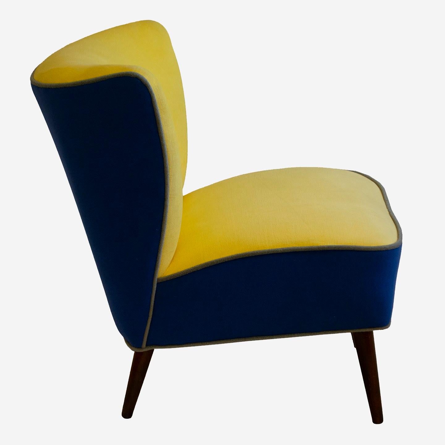This petite slipper chair in the style of James Mont has multiple uses and is suitable as a cheerful accent chair in any room of the house. It has a colorful and playful color scheme, utilizing a blue and yellow combination. This fun piece will