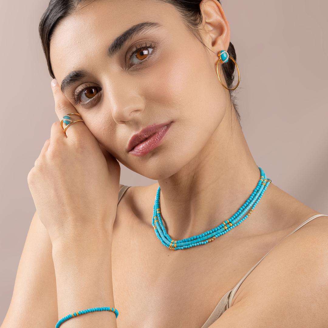 Our Petite Sphere Bead Necklace is strung with a beautiful assortment of vibrant Sleeping Beauty turquoise and 20kt gold bead accents. The rich yellow hues of our gold beads and hardware perfectly complement the mystic blue hues of each turquoise
