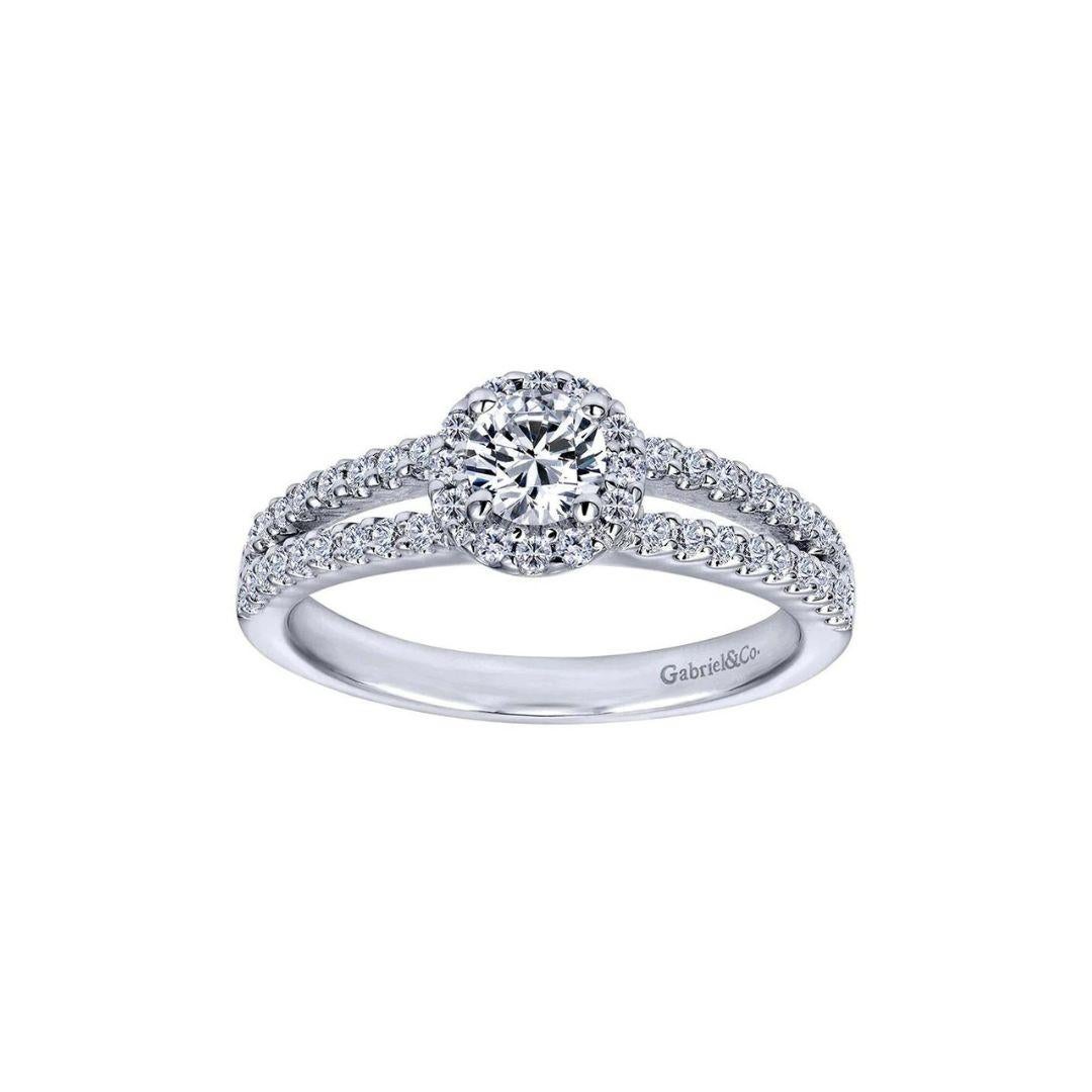 Petite Split Shank Diamond Halo Engagement Ring in 14k White Gold.﻿ Center diamond weighs 0.25 ct, H color, SI1 clarity. Side diamonds are  0.25ctw, H color, SI1 clarity.