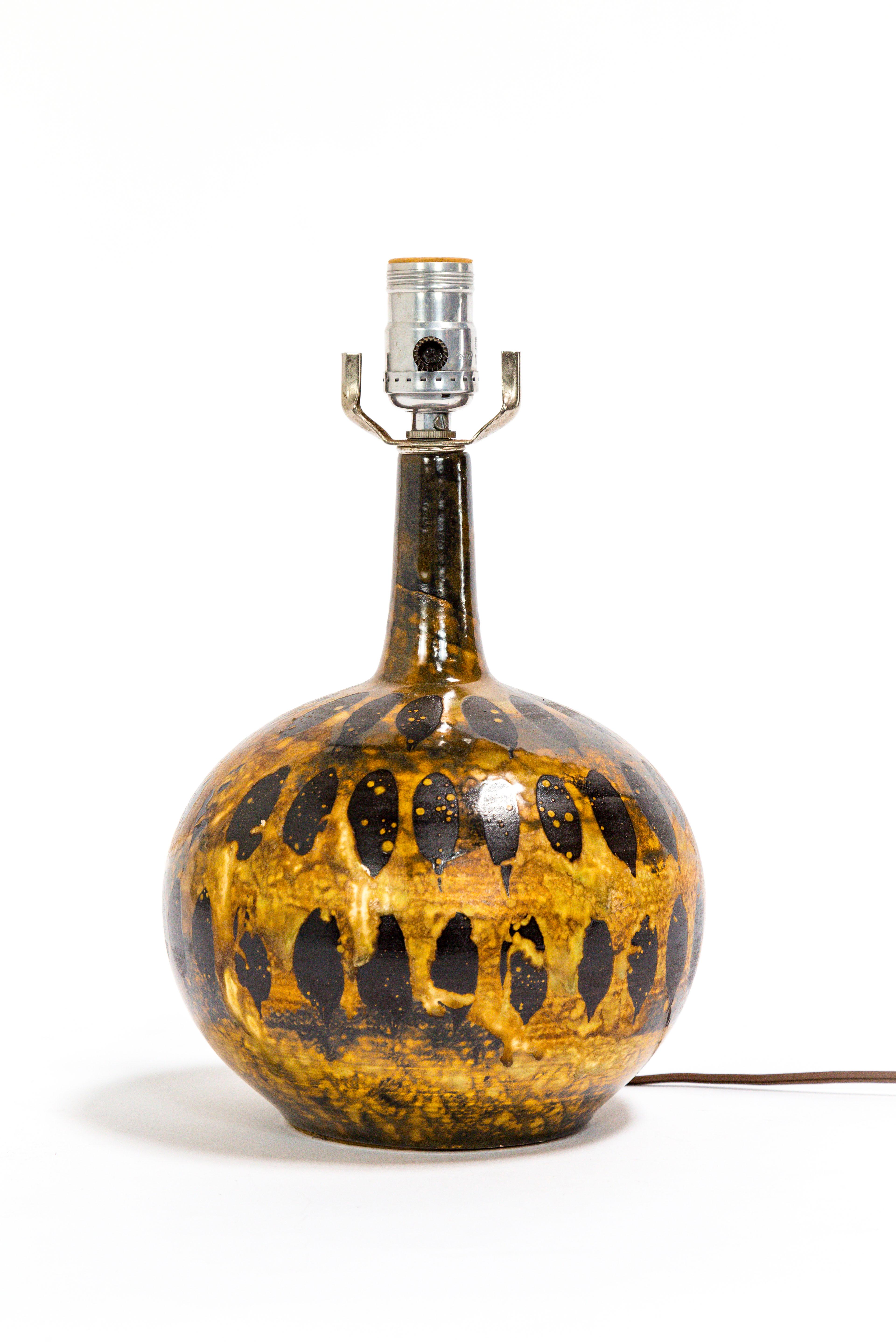 This petite gourd lamp has an incredible, variegated, spotted glaze. A bold, yet versatile piece; great for a side table, desk, or nightstand. Circa 1970's. 12.5