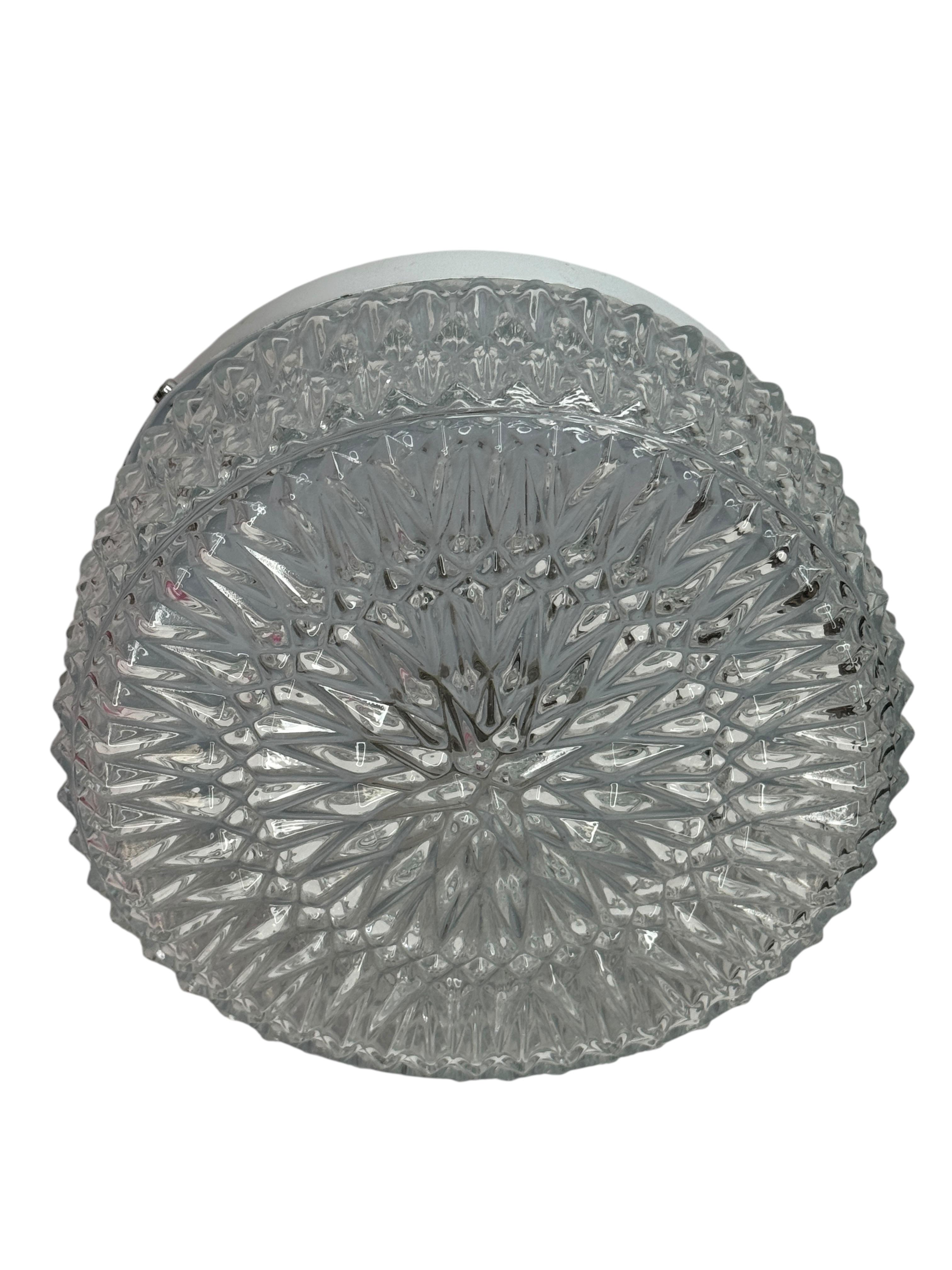 Petite starburst pattern flushmount. Made in Germany attribution to RZB Leuchten. Gorgeous textured glass flush mount with metal fixture. The Fixture requires an European E27 / 110 Volt Edison bulb, up to 60 watts.