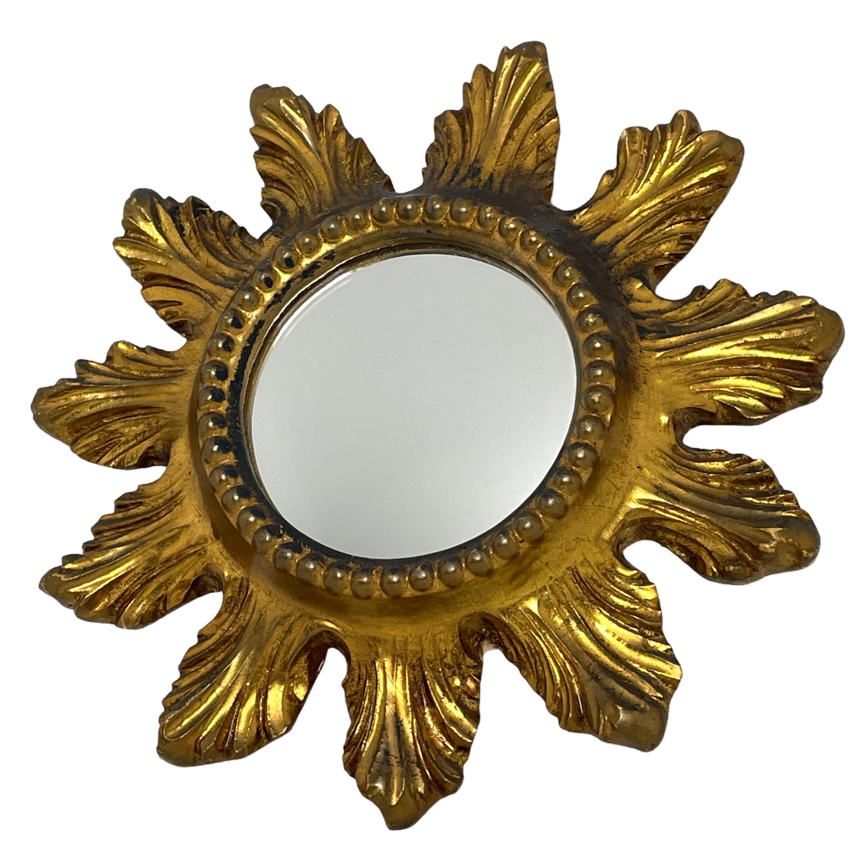A gorgeous starburst mirror. Made of gilded wood and composition. No chips, no cracks, no repairs. It measures approximate 9