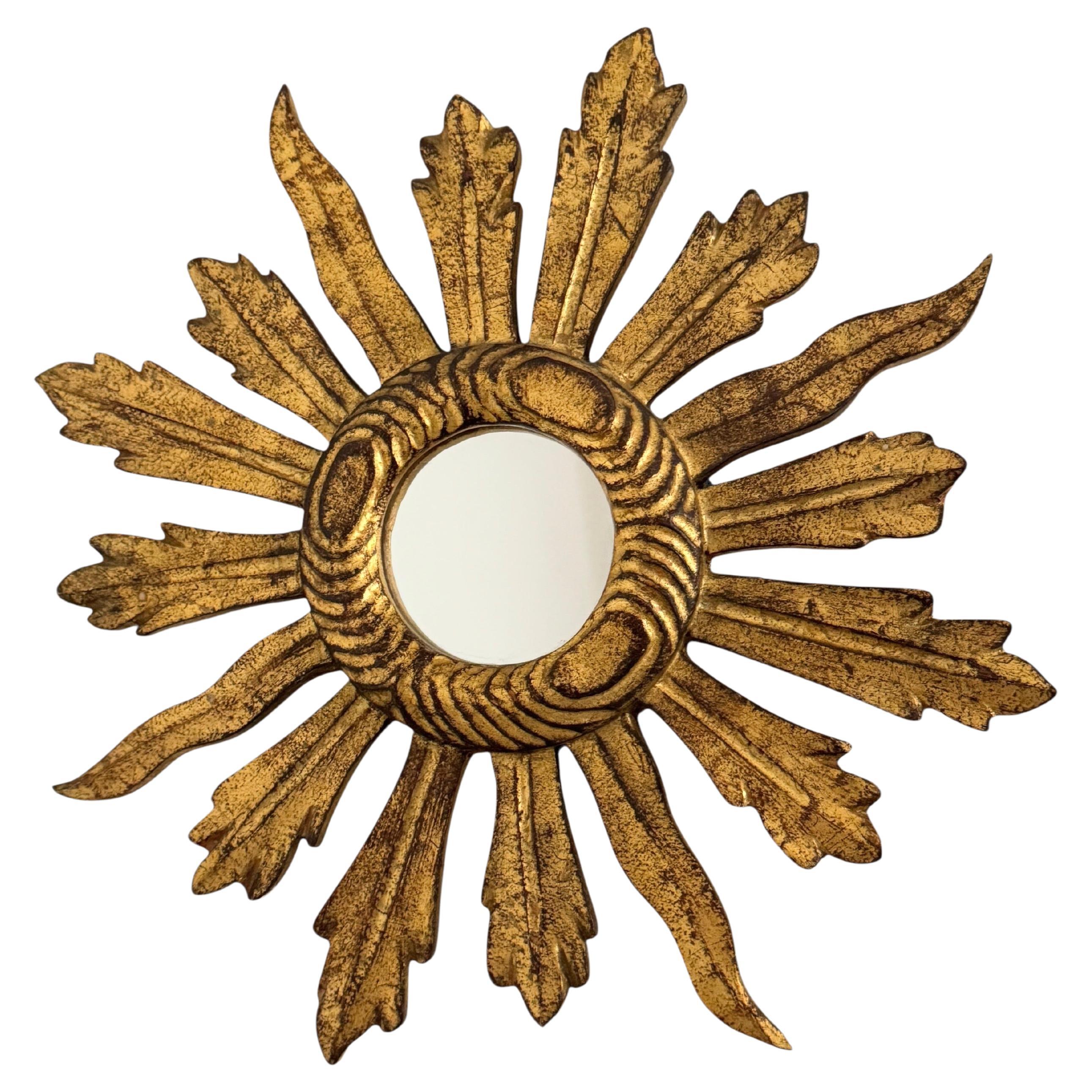 A gorgeous starburst sunburst flat mirror. Made of gilded wood. No chips, no cracks, no repairs. It measures approximate: 14 5/8