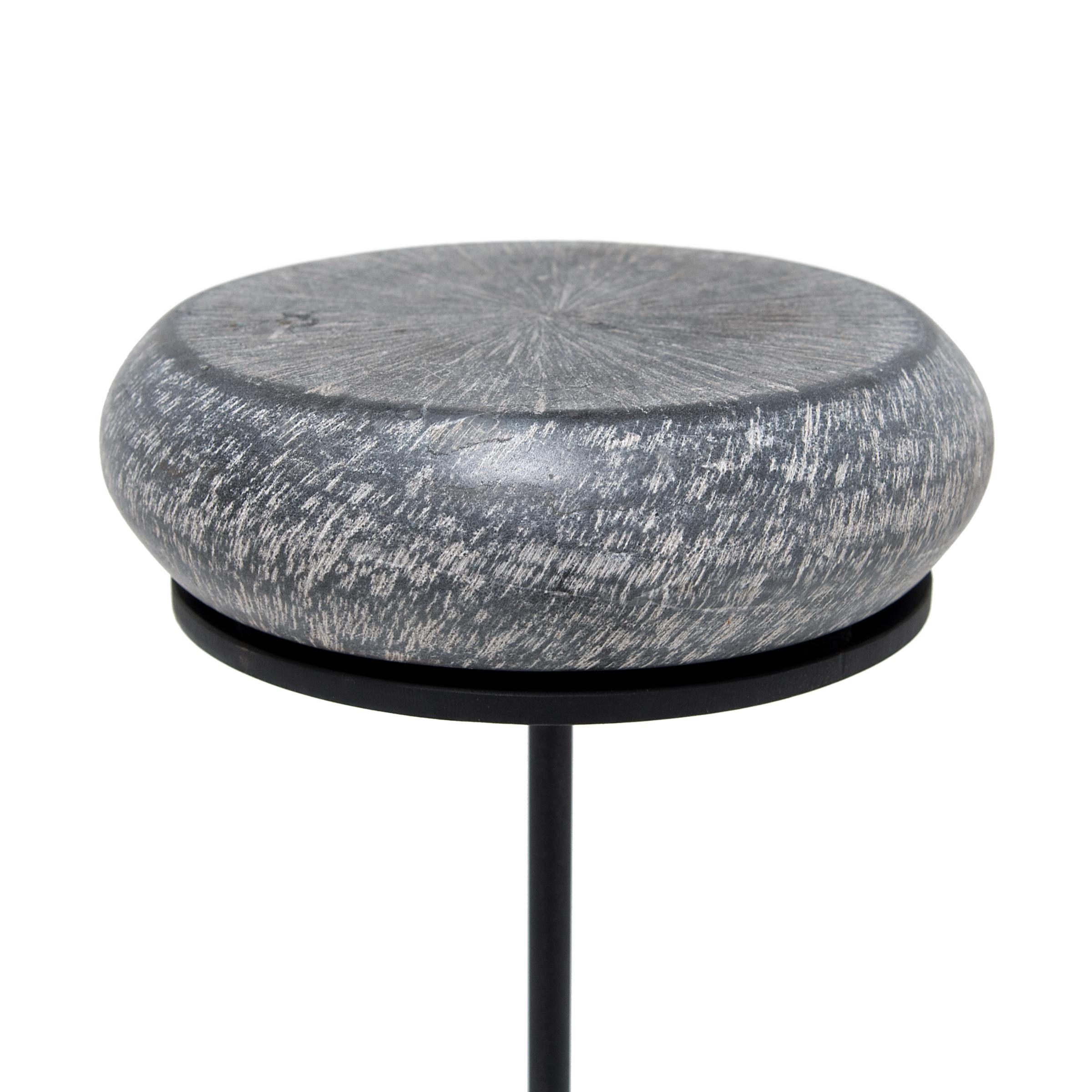 The stone top of this petite drum table references the form of a traditional hand held fish drum. In Taoist mythology the fish drum was the symbol of Zhang Guolao, one of the mythical eight immortals. A storied eccentric, Zhang was believed to have