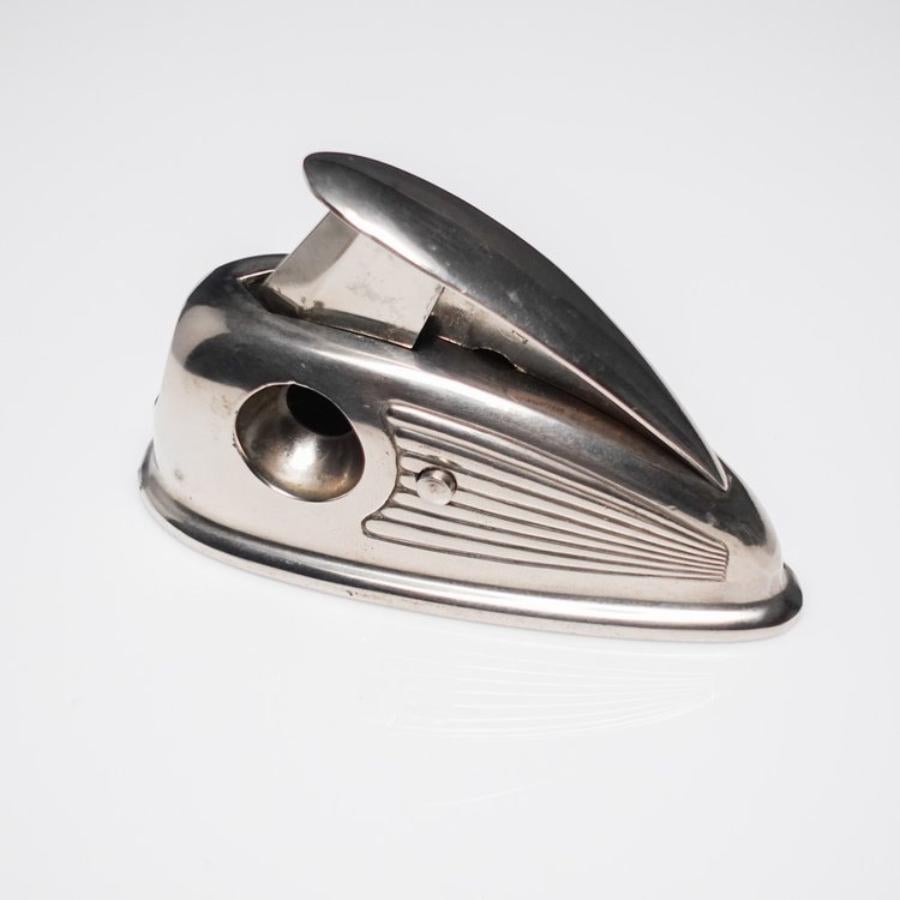 Here is a Petite Streamline 1930s Chrome Art Deco German Cigar Cutter.

This beautifully aerodynamic designed cigar cutter has three holes for different sized cuts. It is small, yet has a great weight and balance. It was manufactured in Germany in