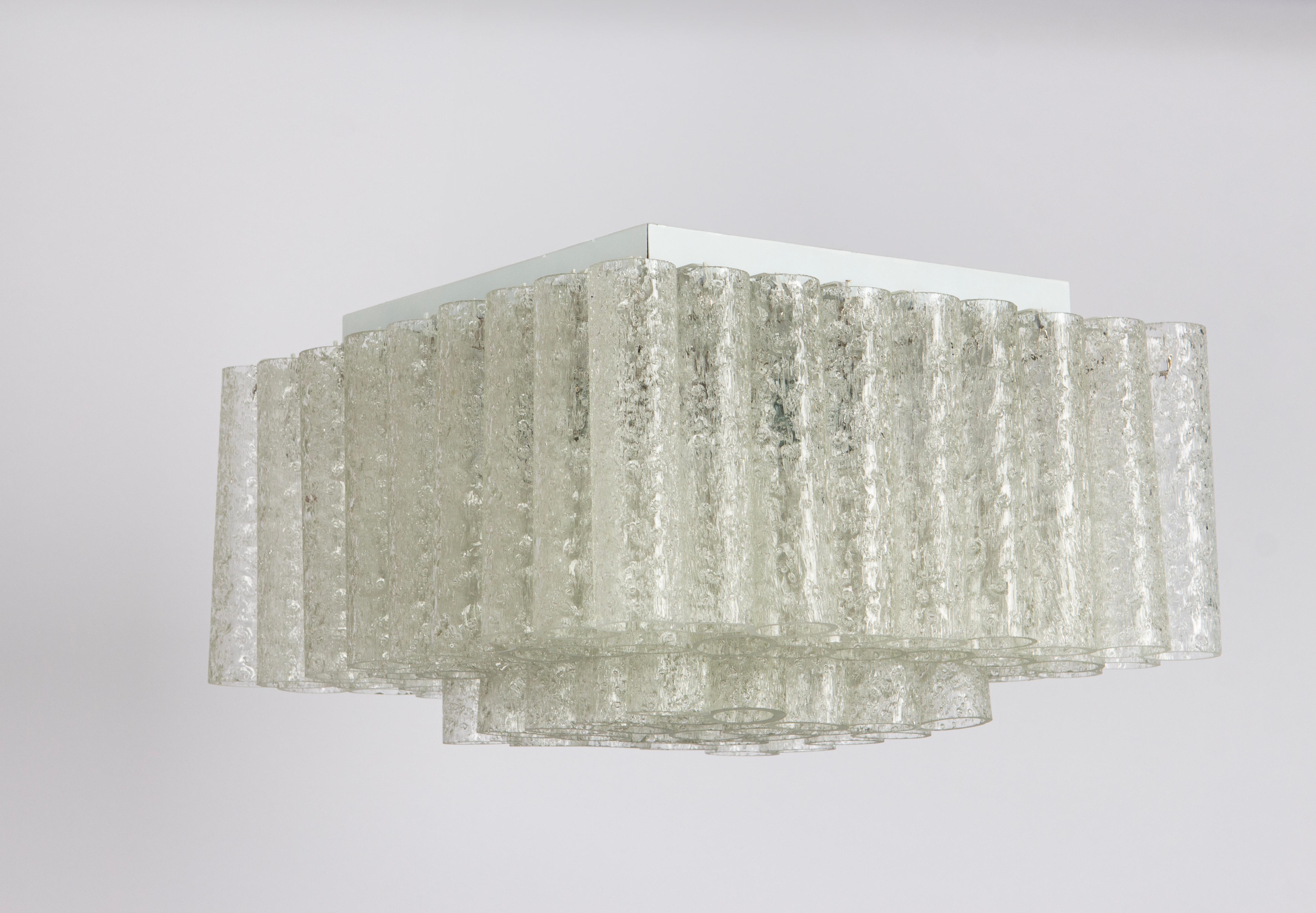 Fantastic big midcentury chandelier by Doria, Germany, manufactured circa 1960-1969. Many Murano glass cylinders are suspended from the fixture.
Wonderful geometric design.
High quality and in very good condition. Cleaned, well-wired and ready to