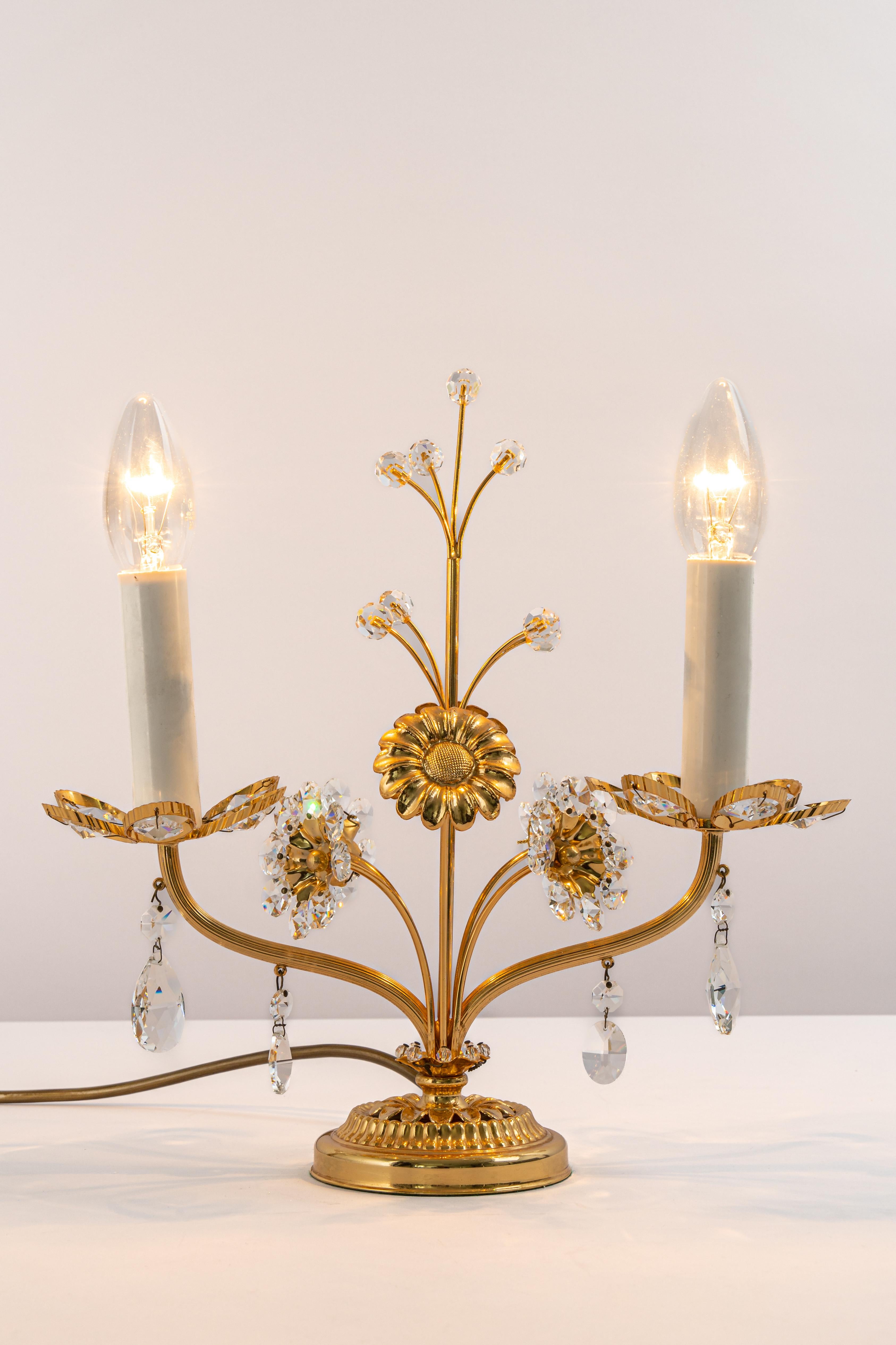 Petite stunning table lamp by Palwa, Germany, 1970s
Gilded brass frame and crystal glasses.

Sockets: The table lamp needs 2 x E14 small bulbs to illuminate.
Light bulbs are not included. It is possible to install this fixture in all countries