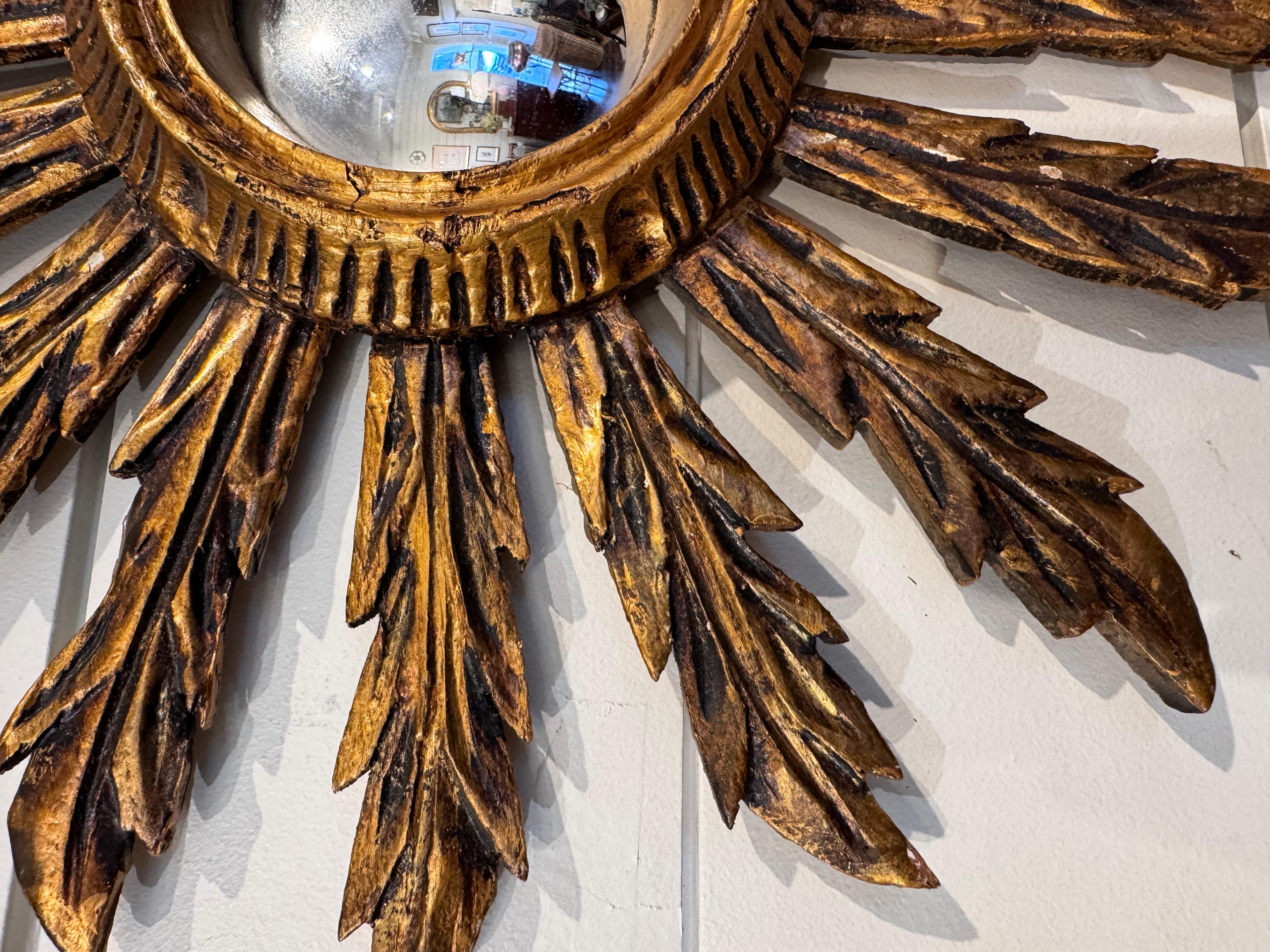 This petite sunburst mirror feature leaf-like rays making it interesting and unusual! It has a rich gold leafed patina and it will add beauty and intent wherever you place it!

Dimensions
15ʺW × 2ʺD × 15ʺH