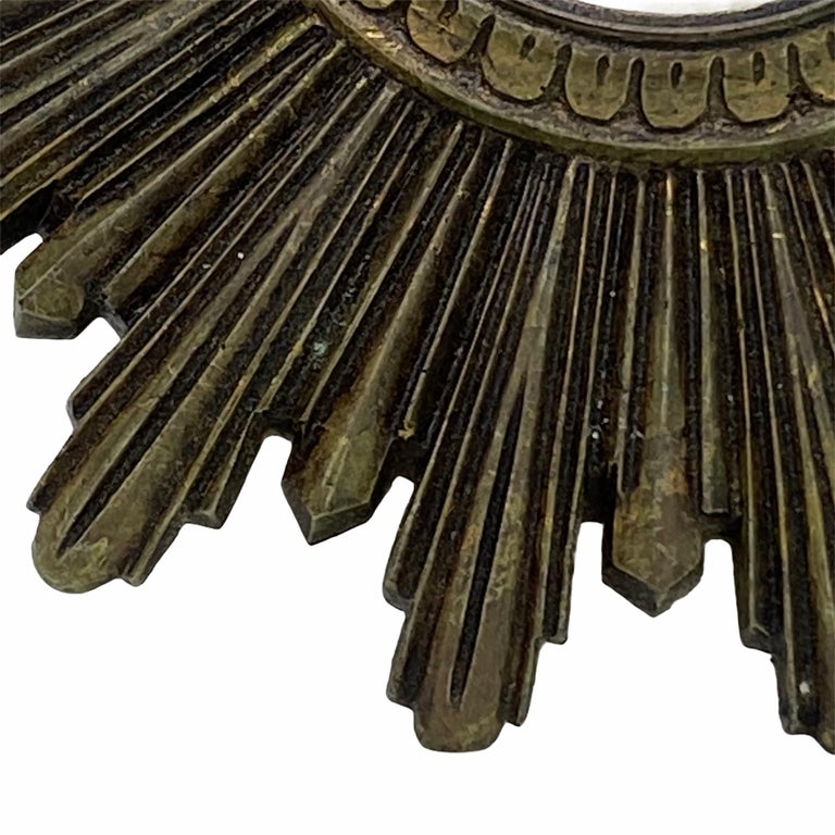 A cute sunburst or starburst mirror. Made of gilded composition. It measures approximate: 9 3/8