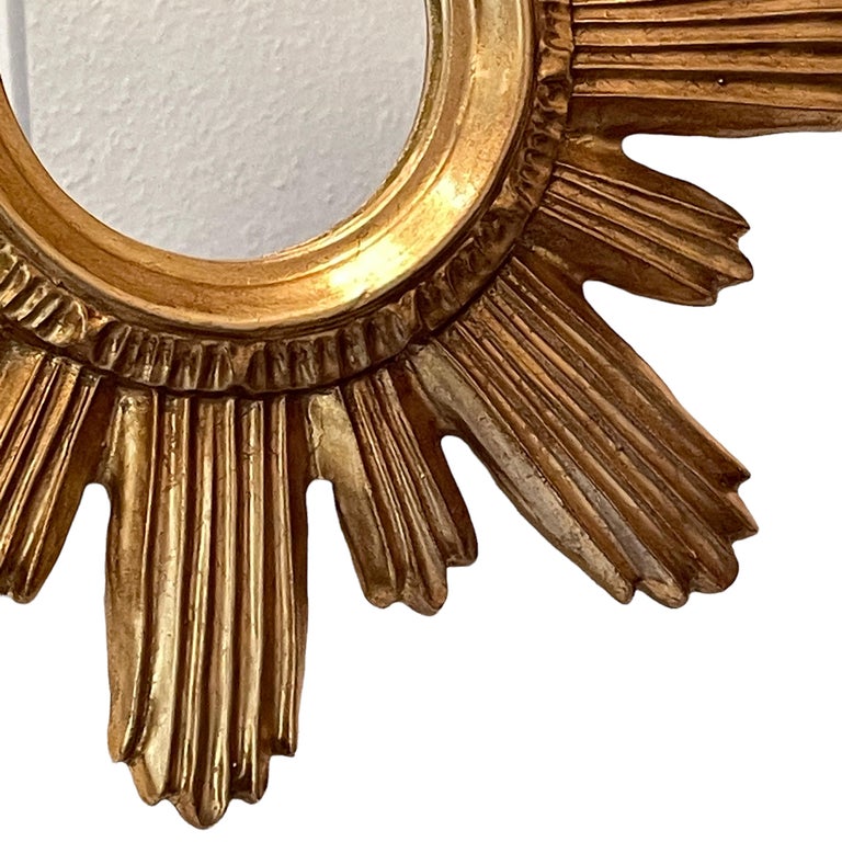 A gorgeous starburst mirror. Made of gilded wood and composition. No chips, no cracks, no repairs. It measures approximate: 14