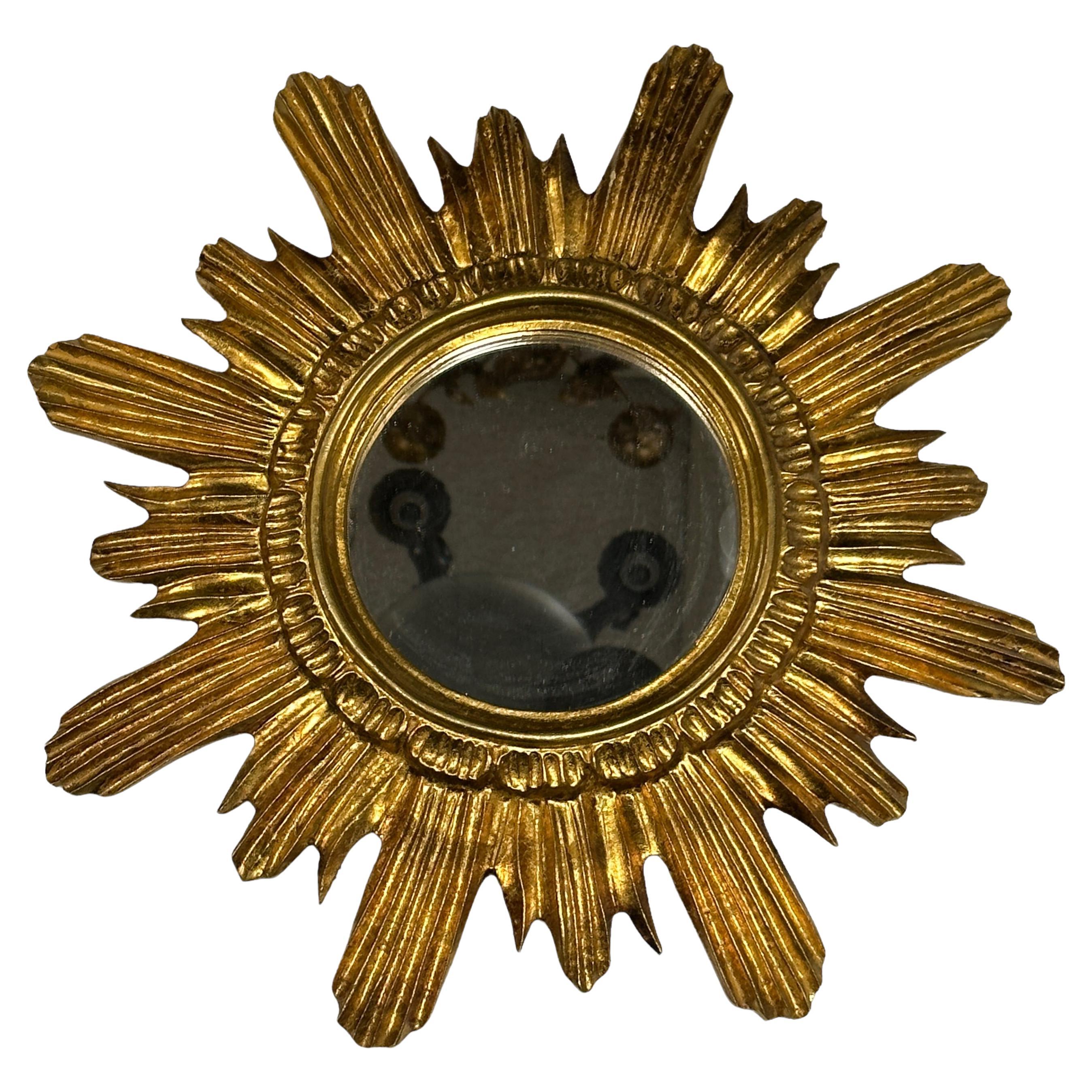 A gorgeous starburst mirror. Made of gilded wood and stucco. No chips, no cracks, no repairs. It measures approximate: 16.5