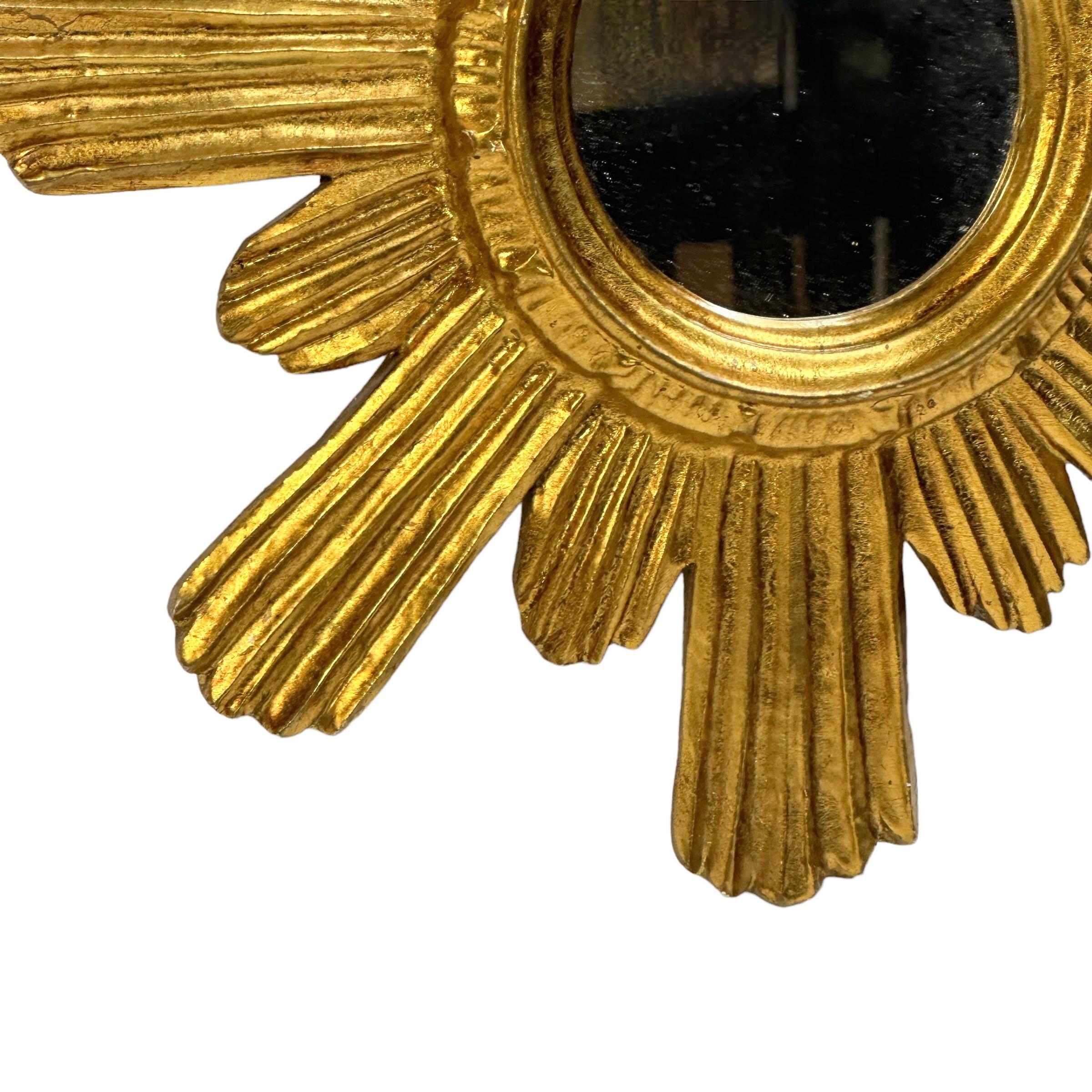A gorgeous starburst mirror. Made of gilded wood and stucco. No chips, no cracks, no repairs. It measures approximate: 14.5