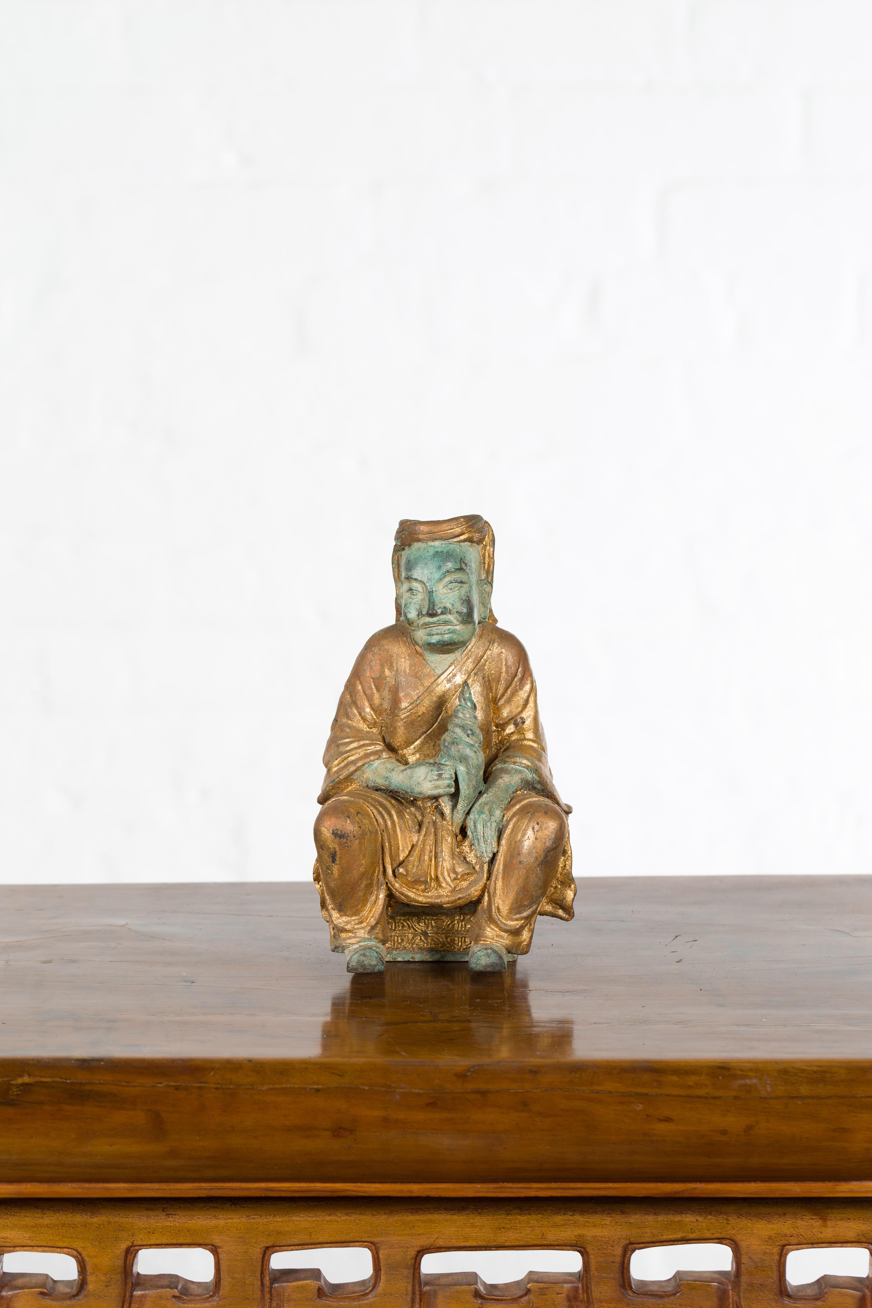 Petite Thai Verde and Gilded Statuette of a Seated Monk Holding a Conch Shell In Good Condition In Yonkers, NY