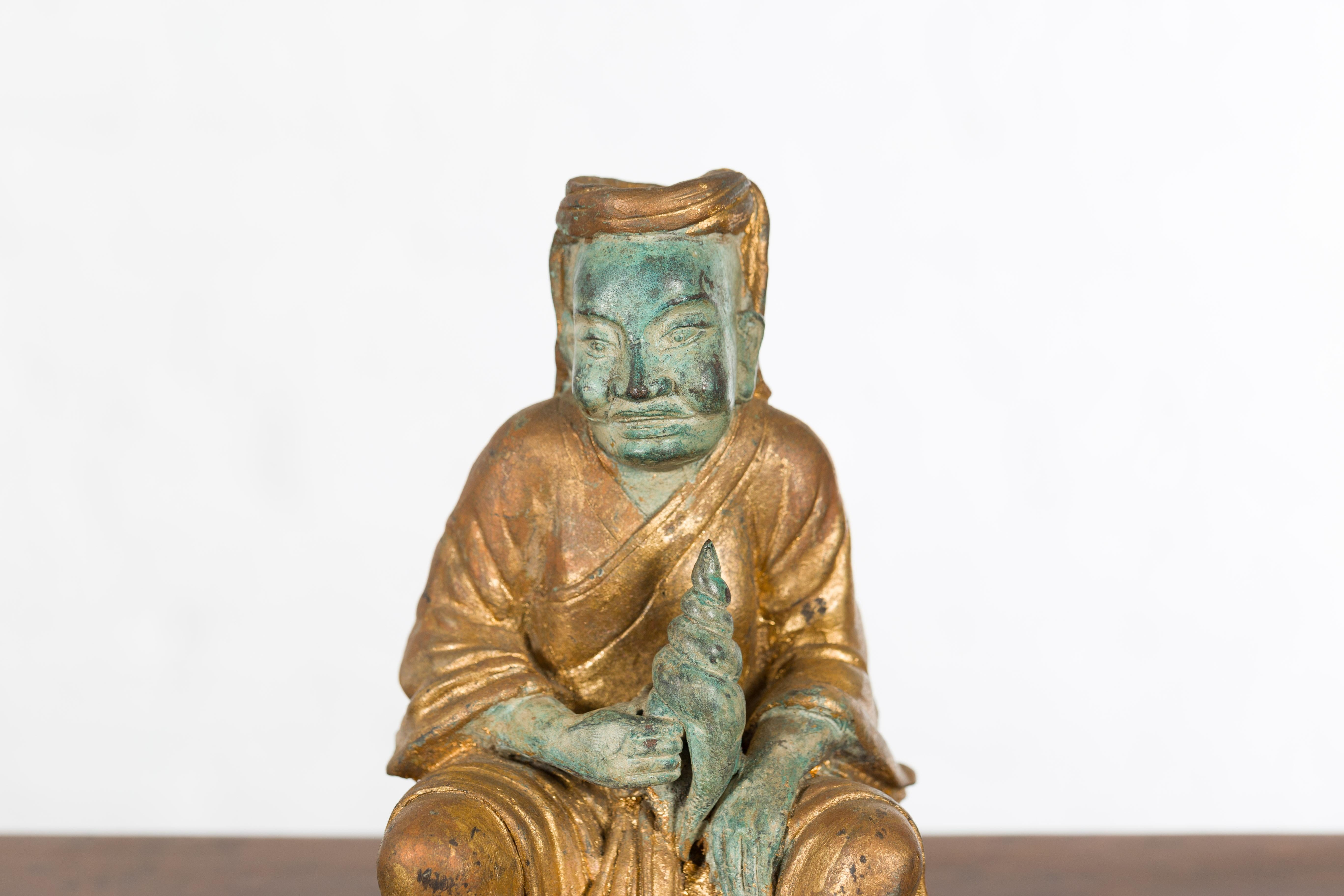 20th Century Petite Thai Verde and Gilded Statuette of a Seated Monk Holding a Conch Shell
