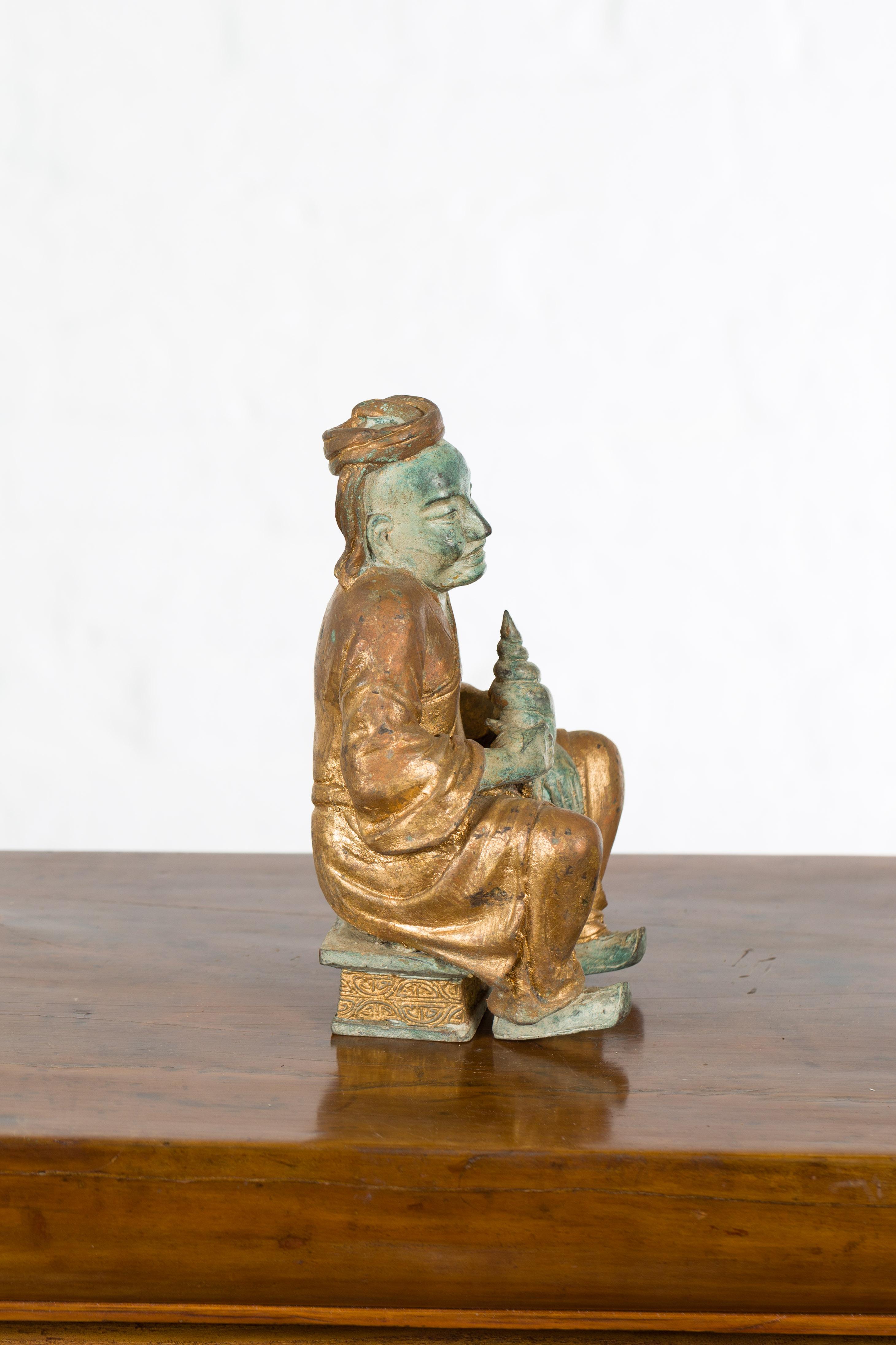 Petite Thai Verde and Gilded Statuette of a Seated Monk Holding a Conch Shell 2