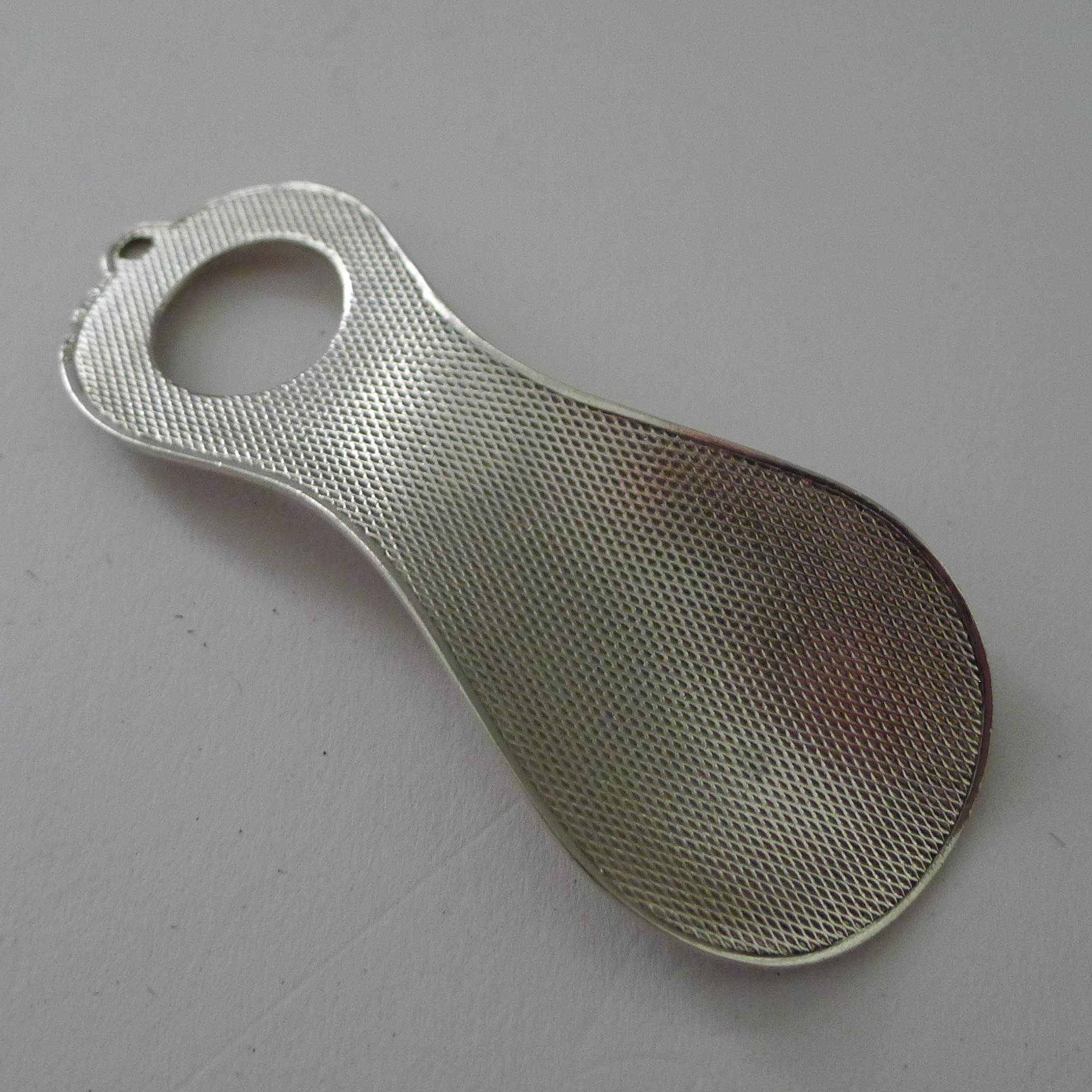 A charming little shoehorn, due to it's smaller size, I assume it was made for travel / pocket use.

Made from solid sterling silver it has an import mark formally hallmarked in the UK for 
London 1928, Art Deco in era with an Art Deco engine-turned