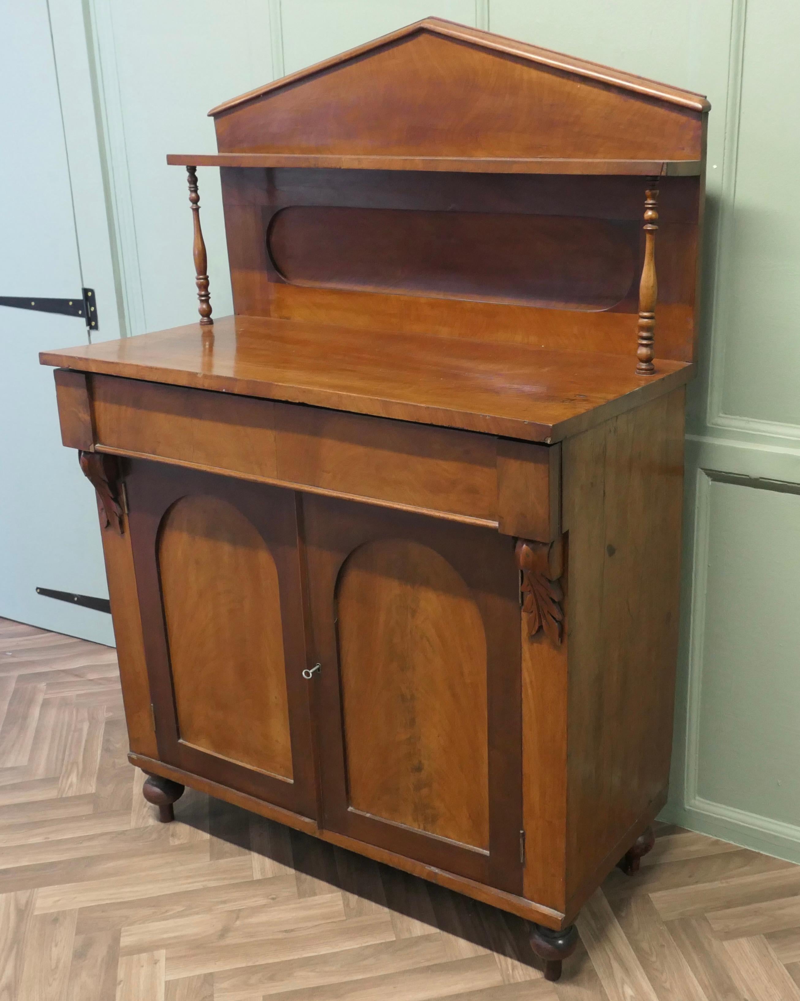 Petite Victorian Mahogany Chiffonier. 

The cupboard has an architectural pointed pediment and a single shelf supported by turned pilasters, it has a concealed drawer over a 2 door shelved cupboard beneath
A very attractive piece in 2 tone mahogany,