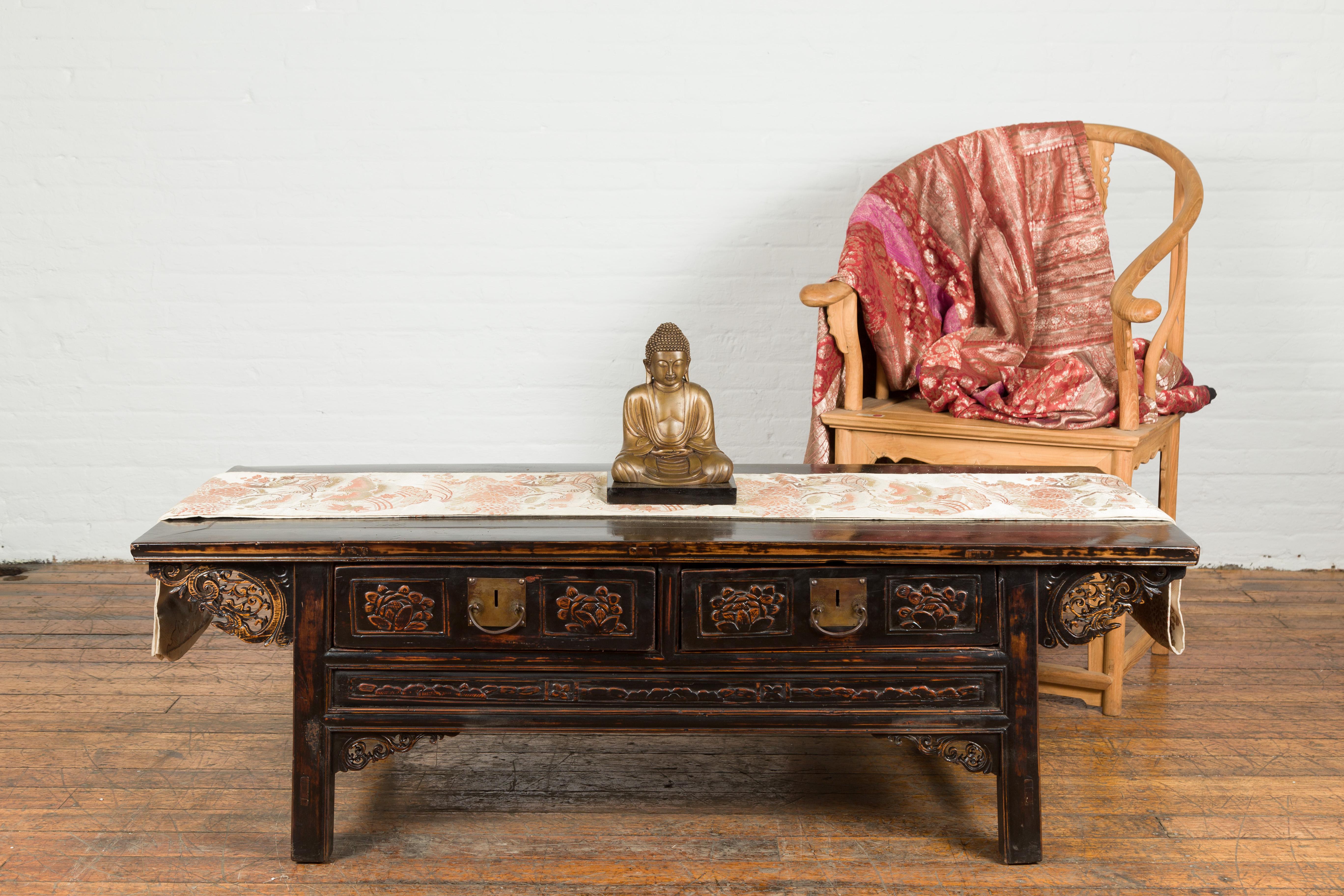 A petite vintage Thai bronze Buddha from the mid 20th century with Dhyana mudra gesture and black base. Created in Thailand during the midcentury period, this petite bronze sculpture depicts a meditative Buddha seated with a gesture called the