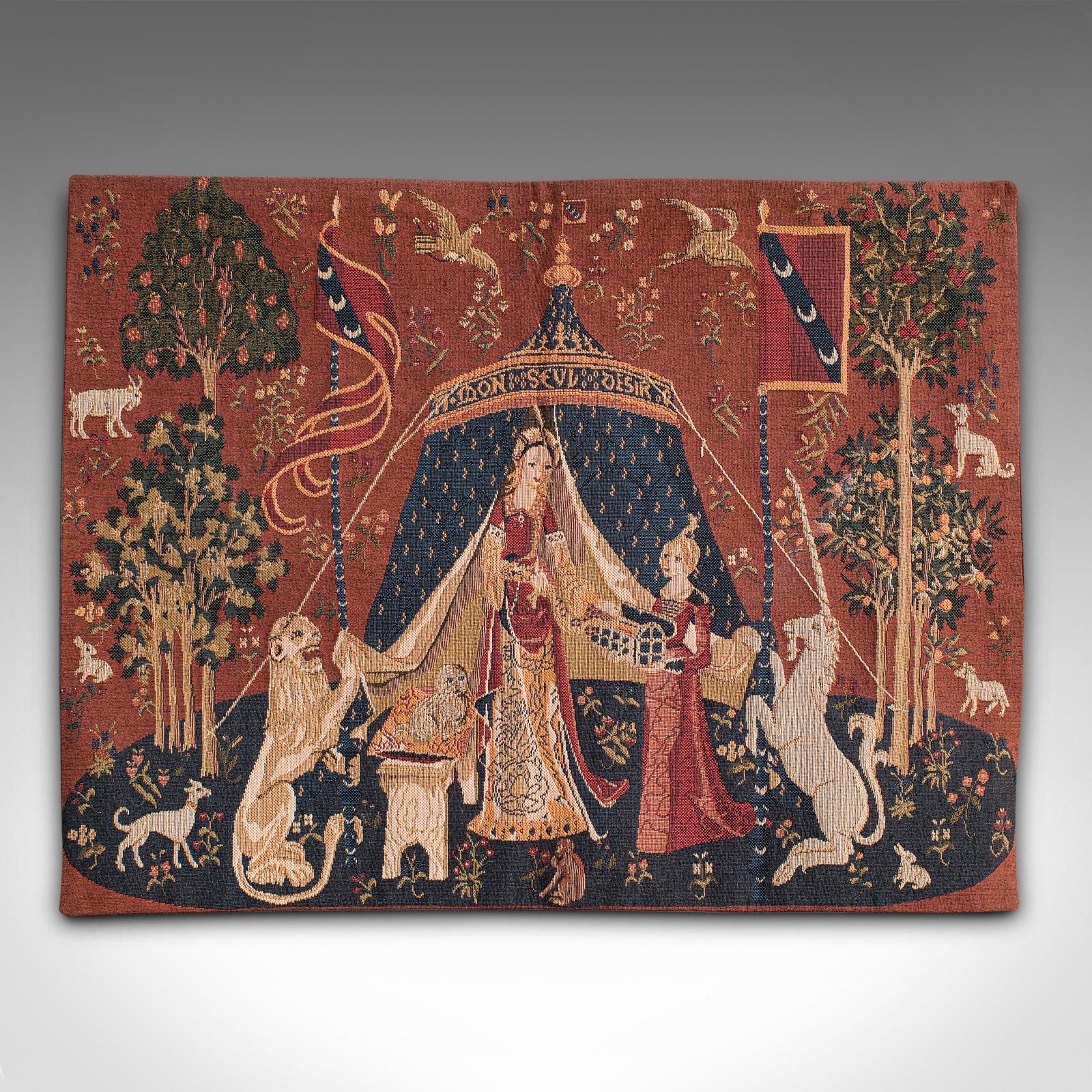 This is a petite vintage tapestry. A French, needlepoint scene depicting The Lady and the Unicorn, dating to the late 20th century, circa 1980.

Of compact proportion, this tapestry is a quality recreation of the 15th century renaissance series of