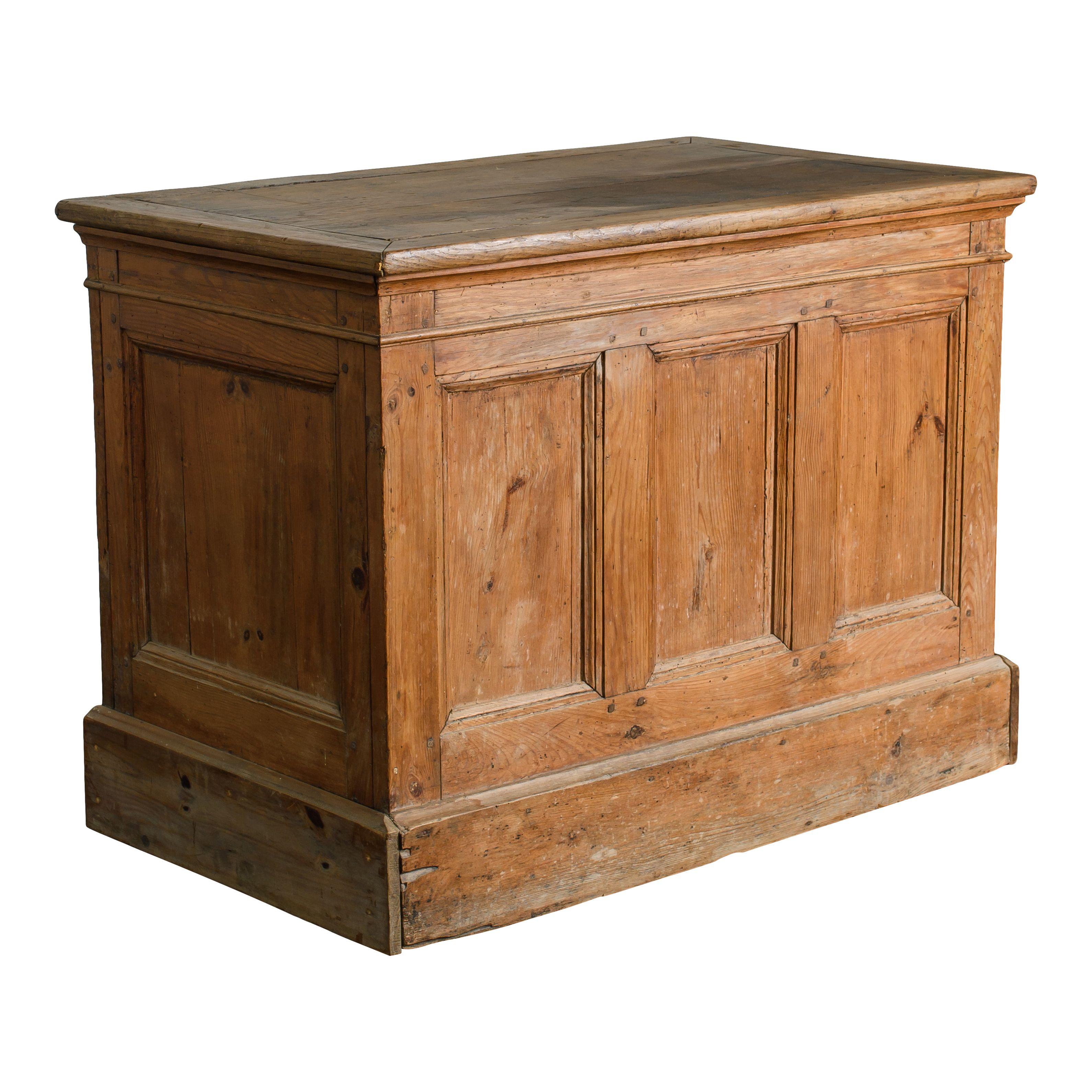 A small vintage wood desk from France. The desk is made of a light wood that shows signs of wear and use, creating the perfect vintage patina. The carved details on the front, sides, and top give the piece dimension and a simple and timeless look.