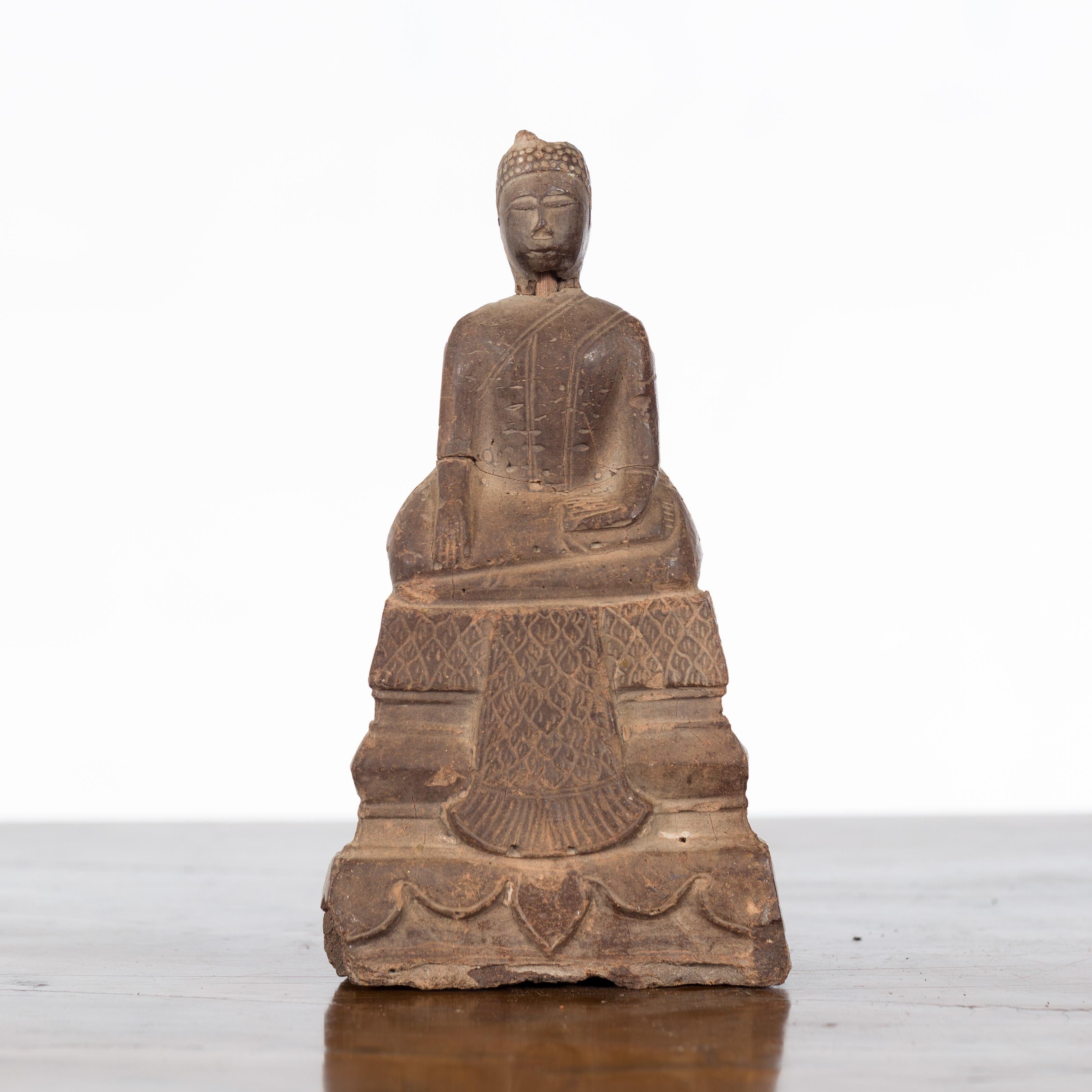 A petite antique Thai wooden Buddha sculpture from the Ayutthaya period, with the Bhumisparsha Mudra, Calling the Earth to Witness. Created in Thailand during the Ayutthaya period (1350–1767), this small sculpture depicts the Buddha seated in the