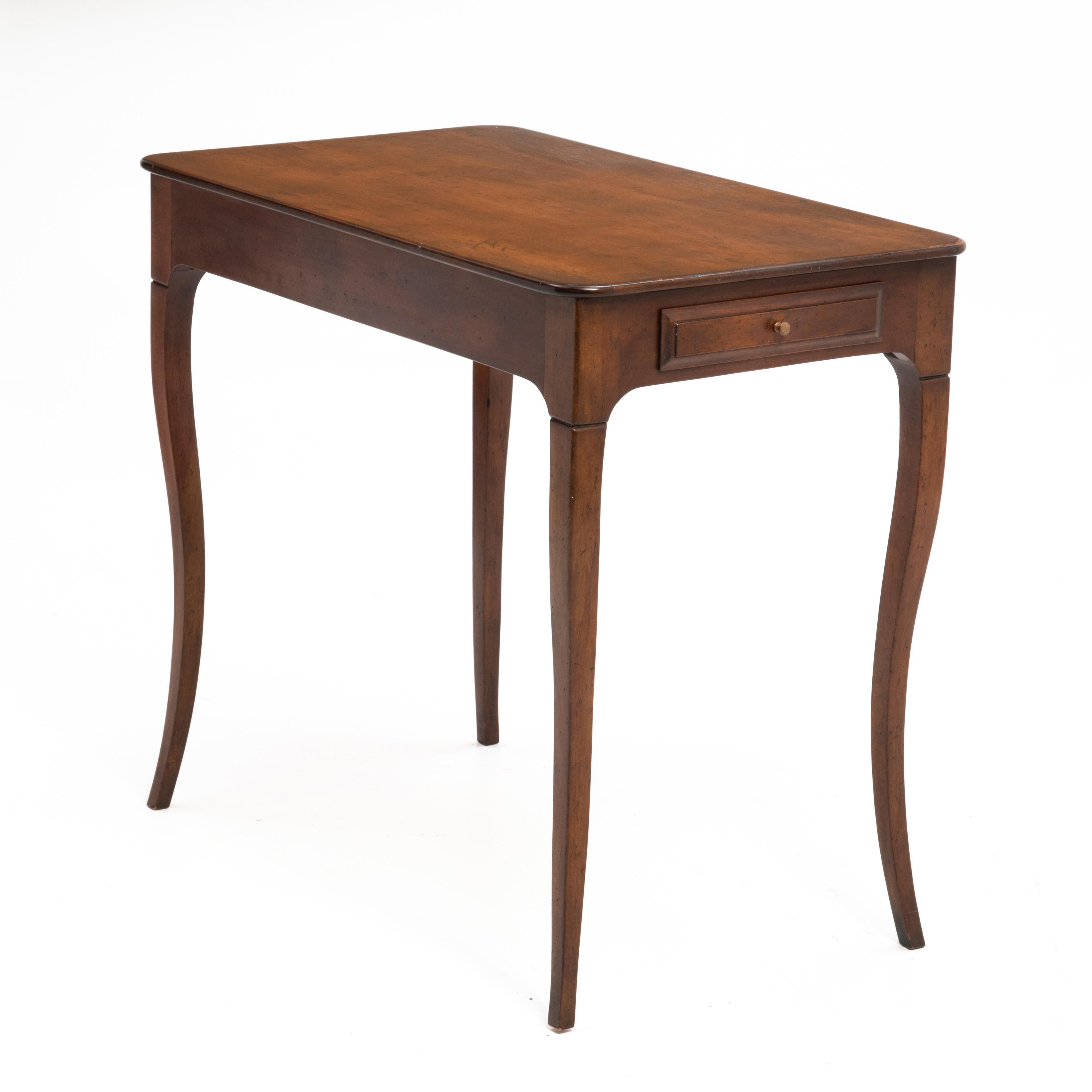 There is some disagreement among us as to where this piece originated. Some say Italy and others France. Either way, it is an elegant and very usable piece. With two drawers, one offset on the front and a second on the side it could serve as a