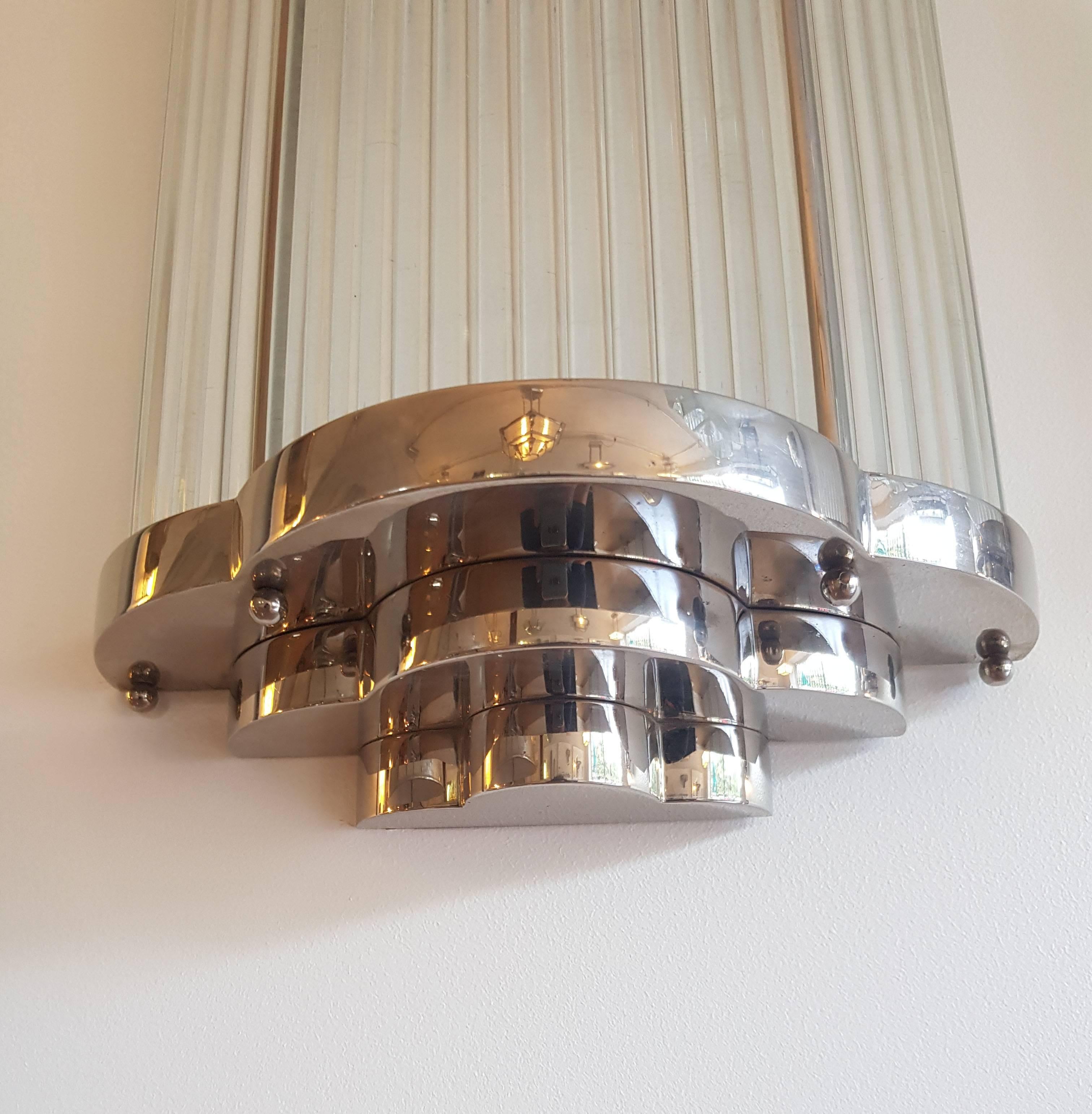 Bronze Art Deco sconce with nickel finish and glass rode.