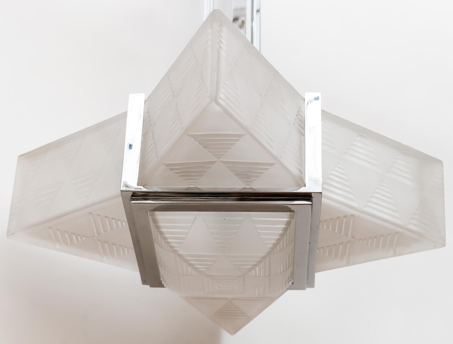 Art Deco Modernist “Triangle” Chandelier dating from the 1930 designed by Henri Petitot and made is his Atelier.

4 Modernist Triangle in thick engraved and sandblated glass, a basin in thick engraved and sandblasted glass and a nickel-plated bronze