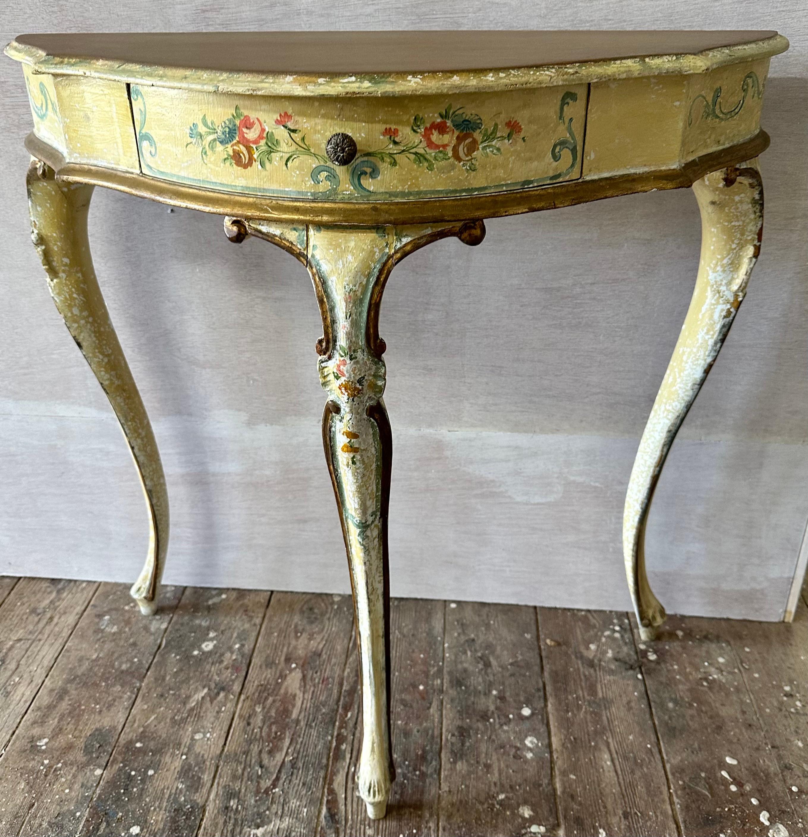 This French Rococo style console table, The distressed ivory painted finish. Three cabriole legs support the table beneath. Beautifully unique, this table will add a bit of romance and mystery to any room.Console table, serpentine top with molded