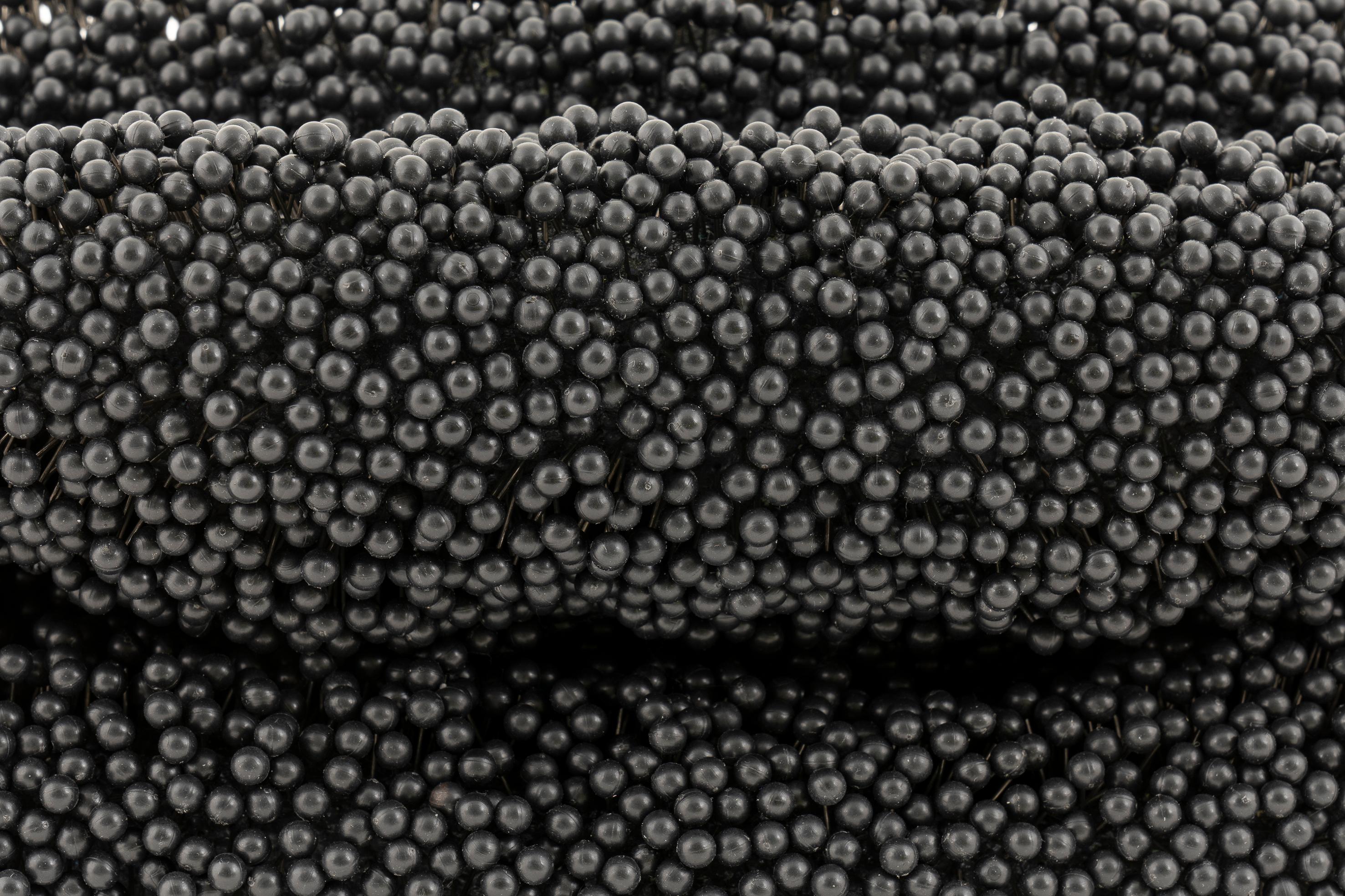 Black Hole, a unique sculpture by artist Petr Pavlik belongs to a series of ‘tabletop sculptures’ made between 2020-21. 

Here the surface of a deflated ball is embellished with over 8,000 map pins. This painstaking process eventually produces a