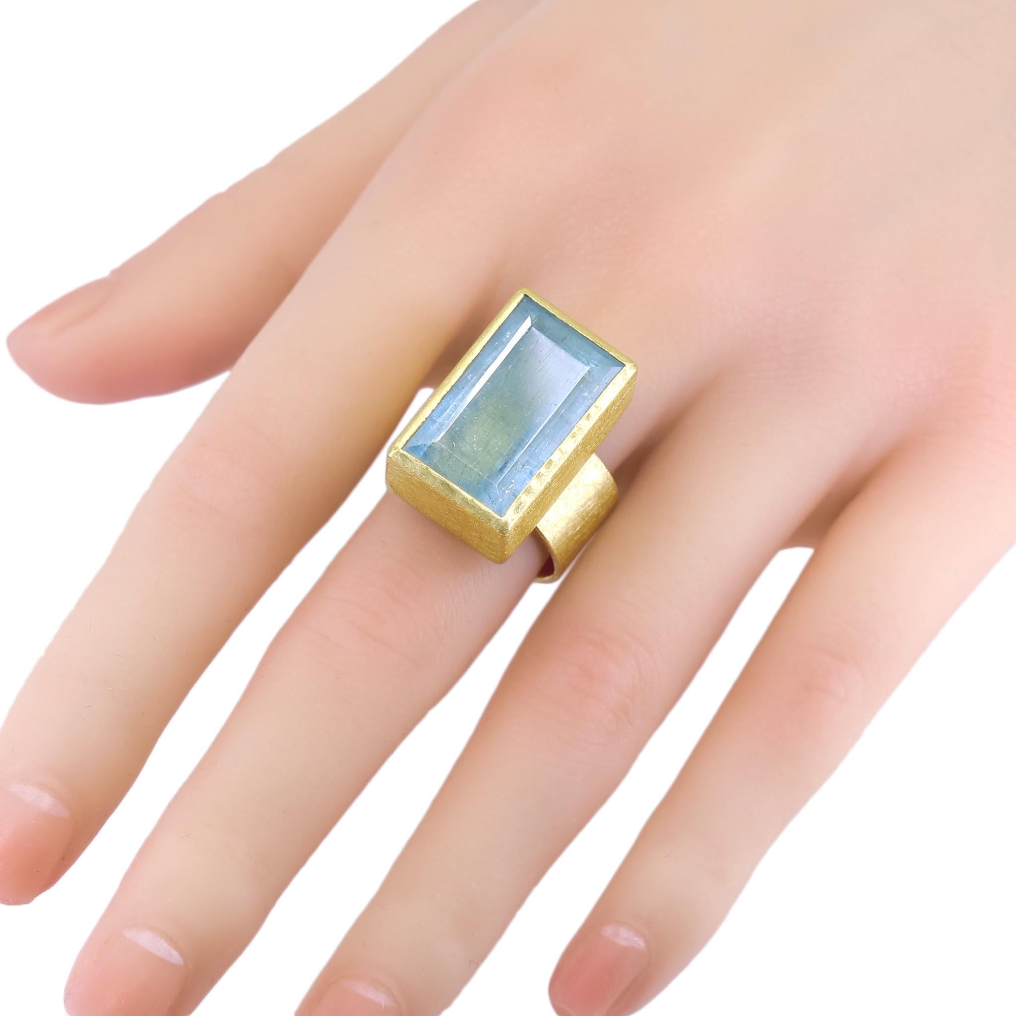 One of a Kind Cocktail Ring hand-fabricated by renowned jewelry maker Petra Class featuring a large 22.45 carat natural rectangular faceted aquamarine bezel-set in signature finished 22k yellow gold atop a 10mm wide 18k yellow gold band. Size 7.5