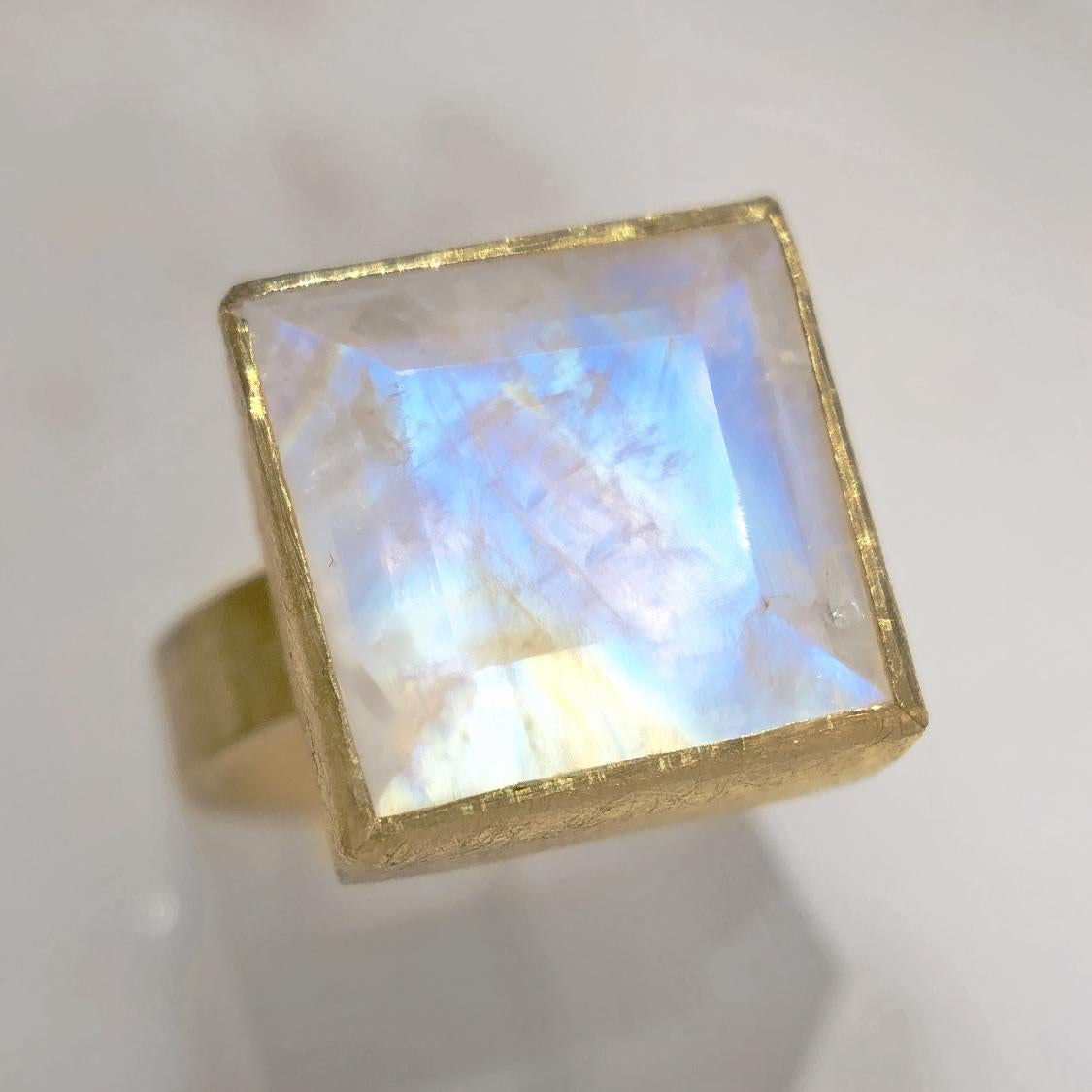 One of a Kind Ring handmade by acclaimed jewelry artist Petra Class in signature finely-textured 22k featuring a spectacular 6.3 carat faceted rainbow moonstone square bezel-set atop a 4mm wide 18k yellow gold band. Size 7.0 (can be sized). Stamped