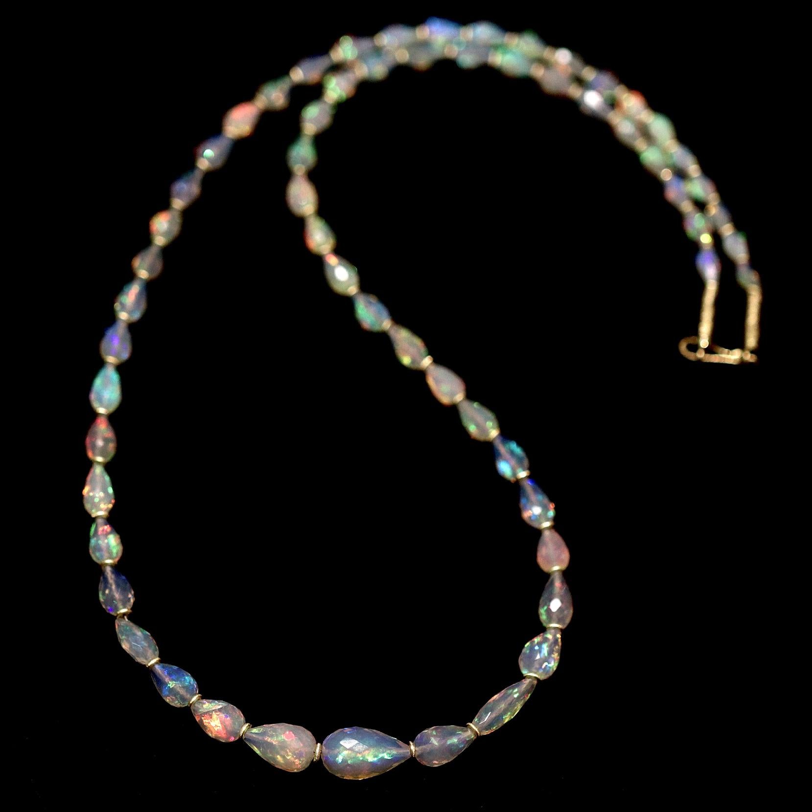 One of a Kind Fiery Faceted Opal Necklace hand-fabricated by acclaimed jewelry maker Petra Class featuring a spectacular array of white Ethiopian opals totaling 47.5 carats, glowing with rainbow fire, individually flanked by 22k yellow gold bead