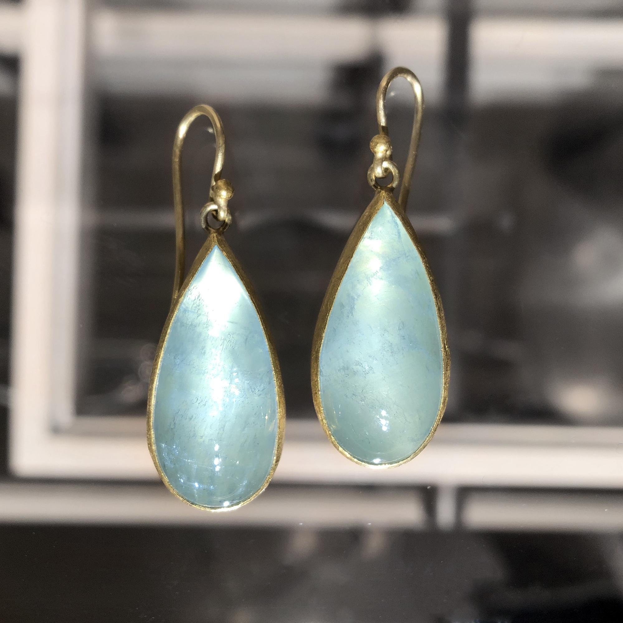One of a Kind Gold Dangle Earrings handcrafted by acclaimed maker Petra Class featuring a phenomenal matched pair of glowing pear-shaped, cabochon-cut aquamarines, bezel-set in the artist's signature-finished 22k yellow gold and linked to 18k yellow