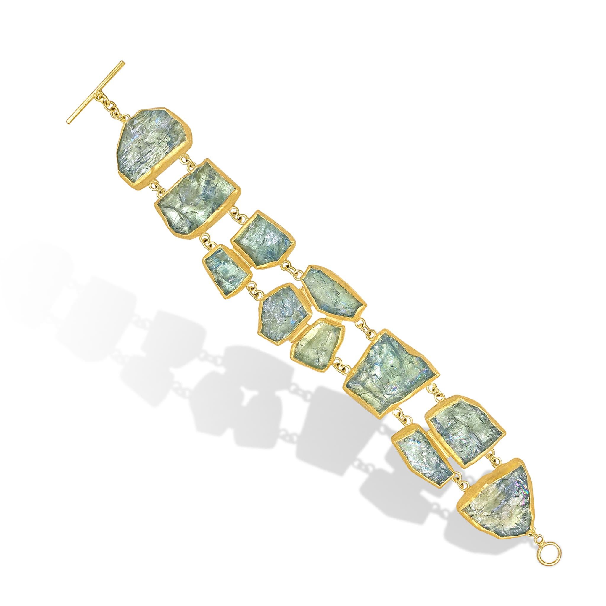 The One of a Kind Iridescent Aquamarine Double Row Bracelet is a true wearable work of art, handcrafted by acclaimed maker Petra Class featuring eleven rough aquamarine gemstones (132.0 carats) with gorgeous rainbow iridescence. The aquamarine