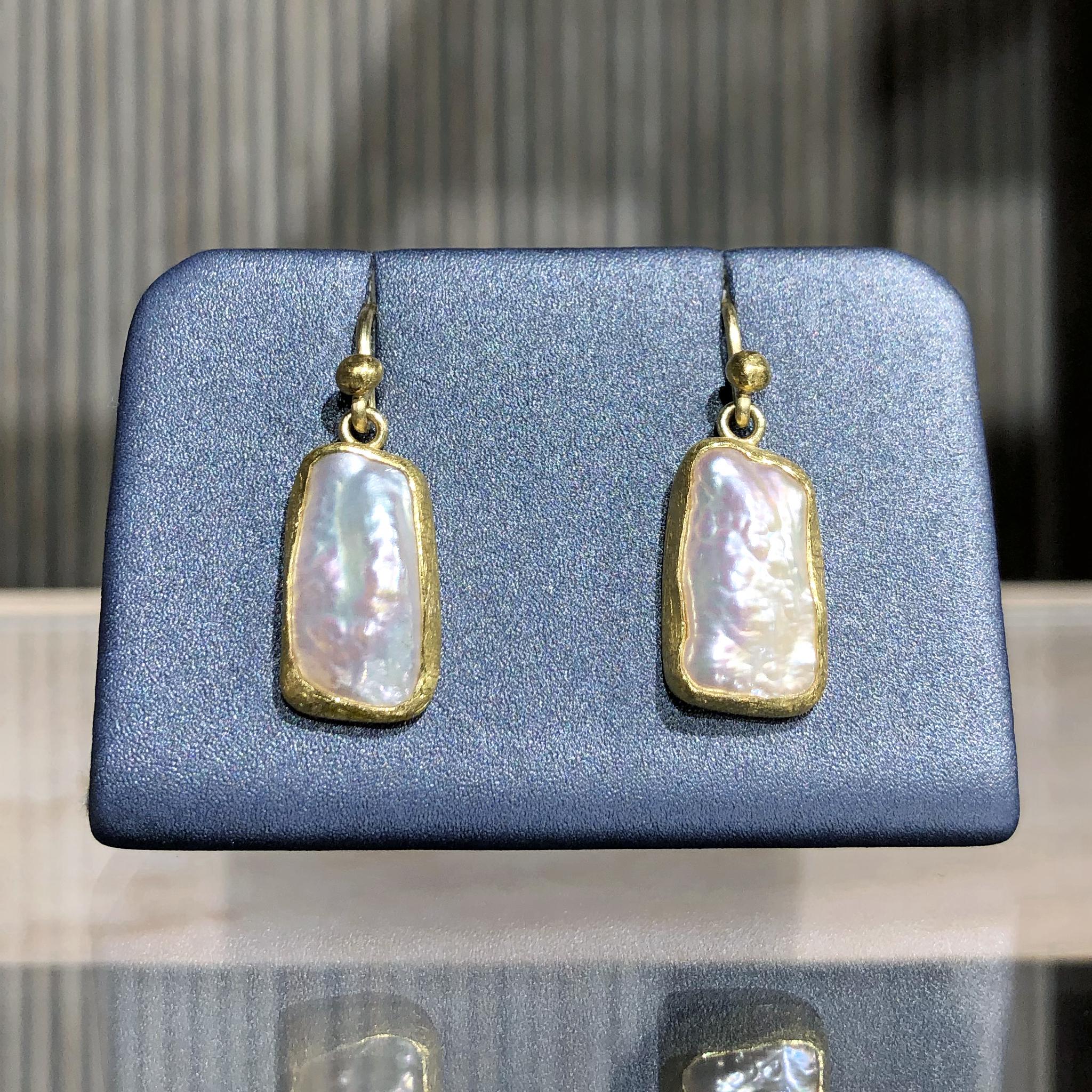 One of a Kind Dangle Drop Earrings handcrafted by jewelry maker Petra Class featuring a stunning pair of iridescent freshwater pearls bezel-set in signature-finished 22k yellow gold and attached to 18k yellow gold ear wires. Stamped and hallmarked