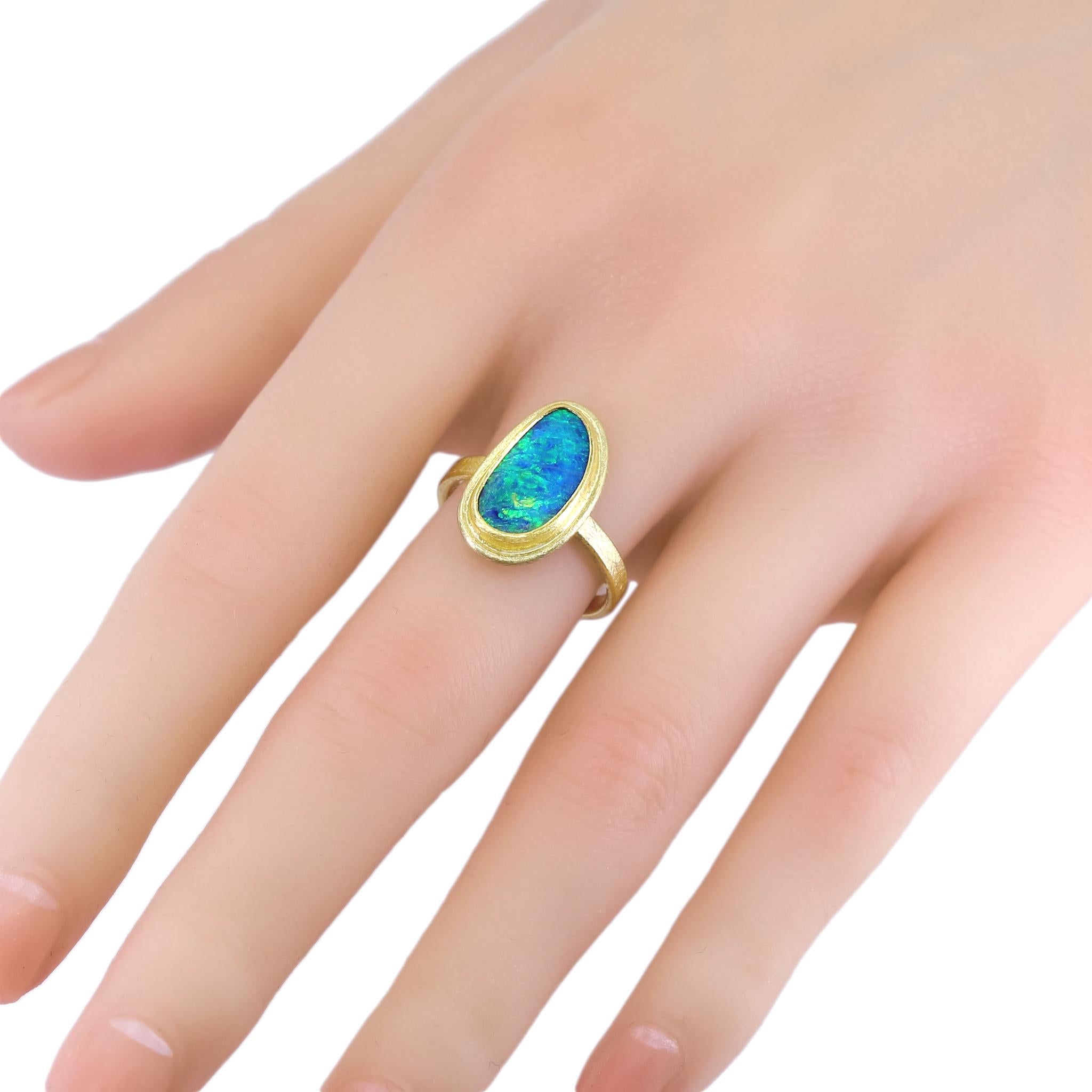 Framed Solitaire Ring handcrafted by acclaimed jewelry maker Petra Class featuring a gorgeous vibrant blue Australian opal doublet (15mm x 9mm) with strong electric green fire complemented by flashes of orange and violet, bezel-set and framed in the