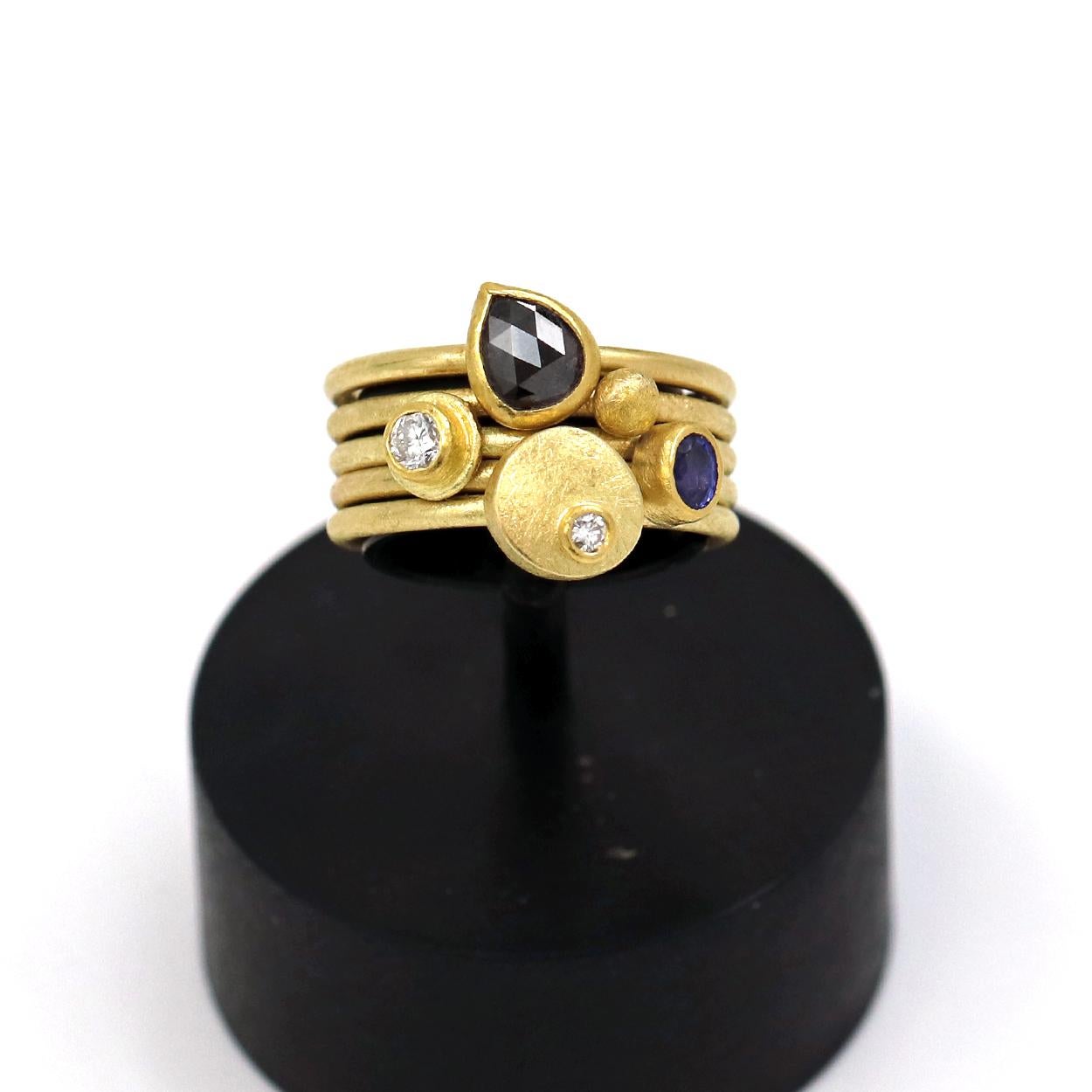 One-of-a-Kind Stacking Ring Set (also available individually) hand-fabricated by jewelry maker Petra Class in her signature-finished 22k yellow gold on 18k yellow gold bands. Showcasing bezel-set gemstones from top to bottom:

1. Framed Round