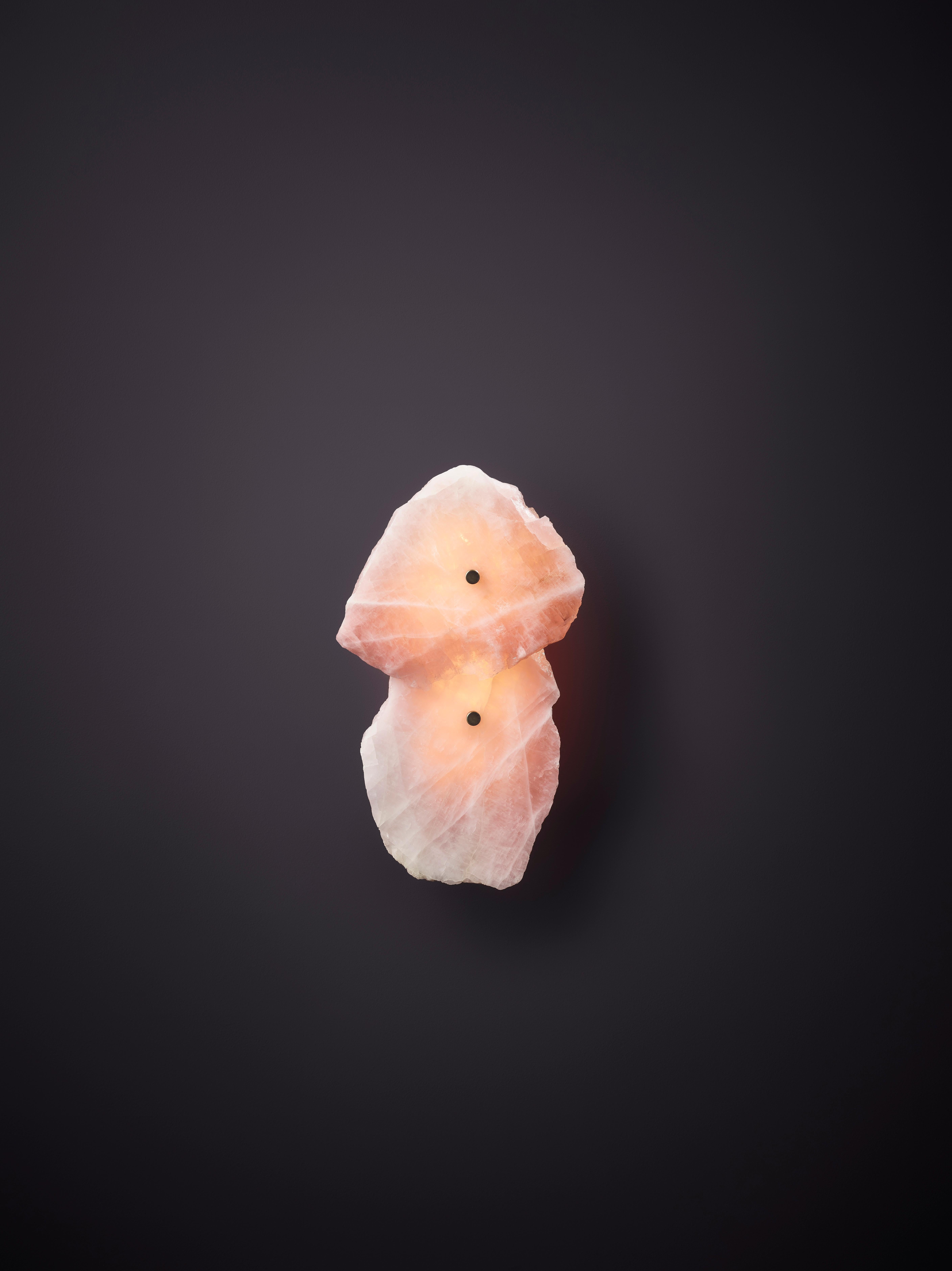 Petra I Twin Rose Quartz Sconce by Christopher Boots
Dimensions: D 12 x W 30 x H 45 cm.
Materials: Aged brass, slices of polished rose quartz.

Available in clear, rose, or smoky quartz. Please contact us.

PETRA (from the Greek word Πέτρα, meaning