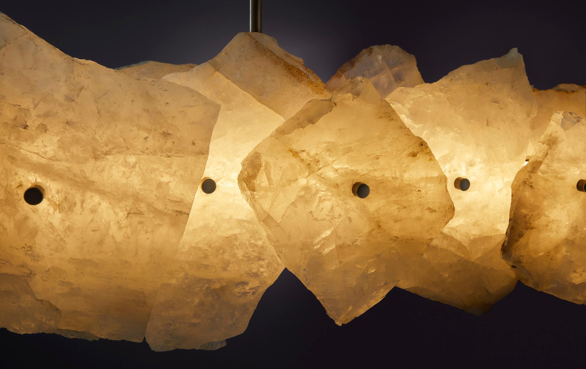 Petra (from the Greek word ??t?a, meaning stone) celebrates the complexity and subtleties in the material composition in Quartz that Petra is made from. Evoking strong connections to deep earth geology, Petra radiates light through subtle tones and