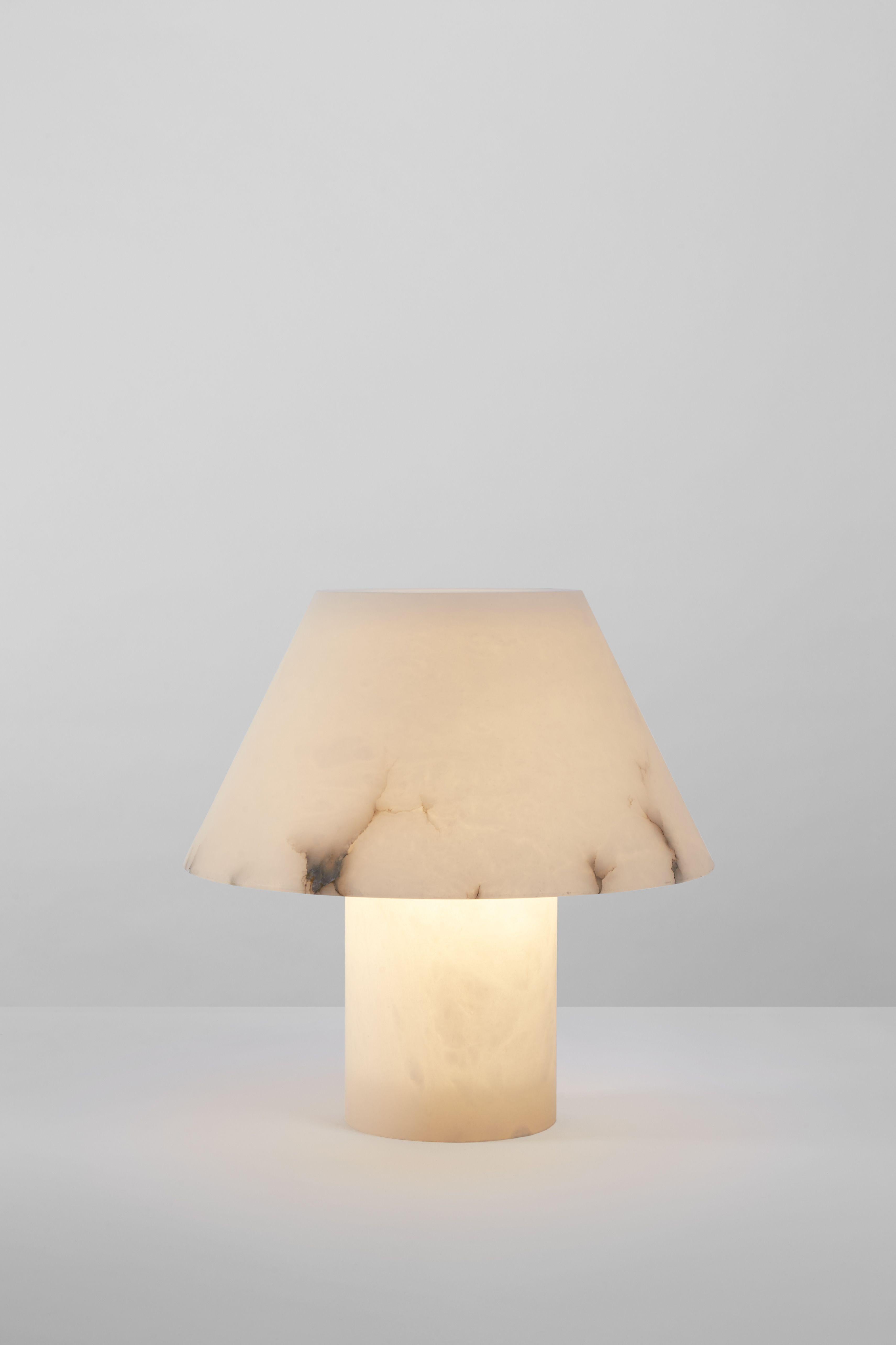 Petra M Me

Base and diffuser in alabaster. Dimmer placed in the electrical cord. By Jordi Veciana, 2020.
Manufactured by Parachilna.


A cylindrical base, a conical shade both made from a single piece of alabaster. Pure utility, pure material.