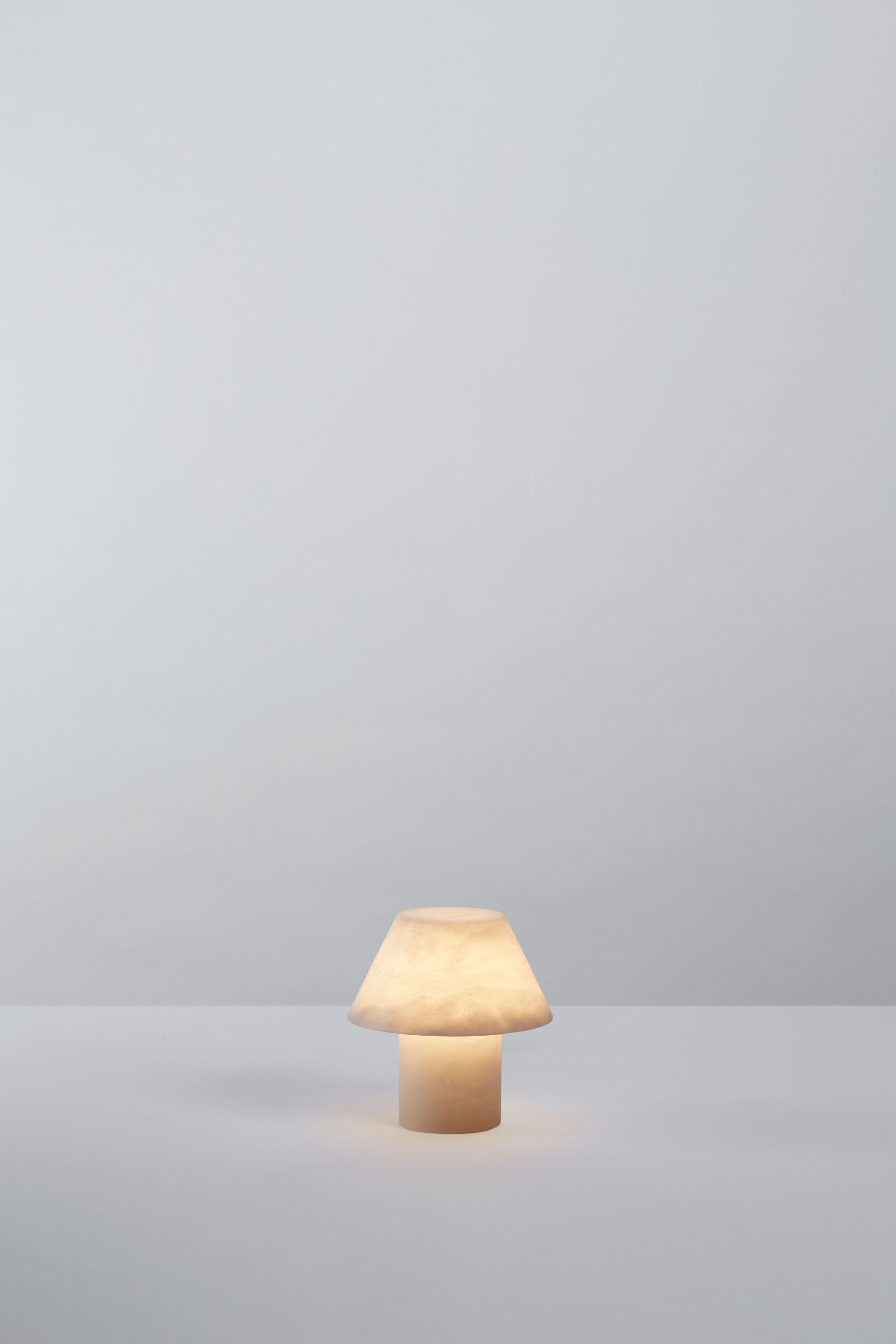 Petra M PE

Base and diffuser in alabaster. Dimmer placed in the electrical cord. By Jordi Veciana, 2020.
Manufactured by Parachilna.


A cylindrical base, a conical shade both made from a single piece of alabaster. Pure utility, pure material.