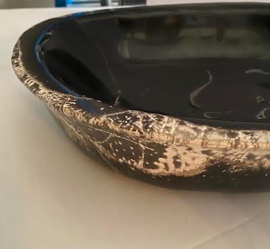 Indonesian freeform shaped petrified wood bowl
Black in color.
 