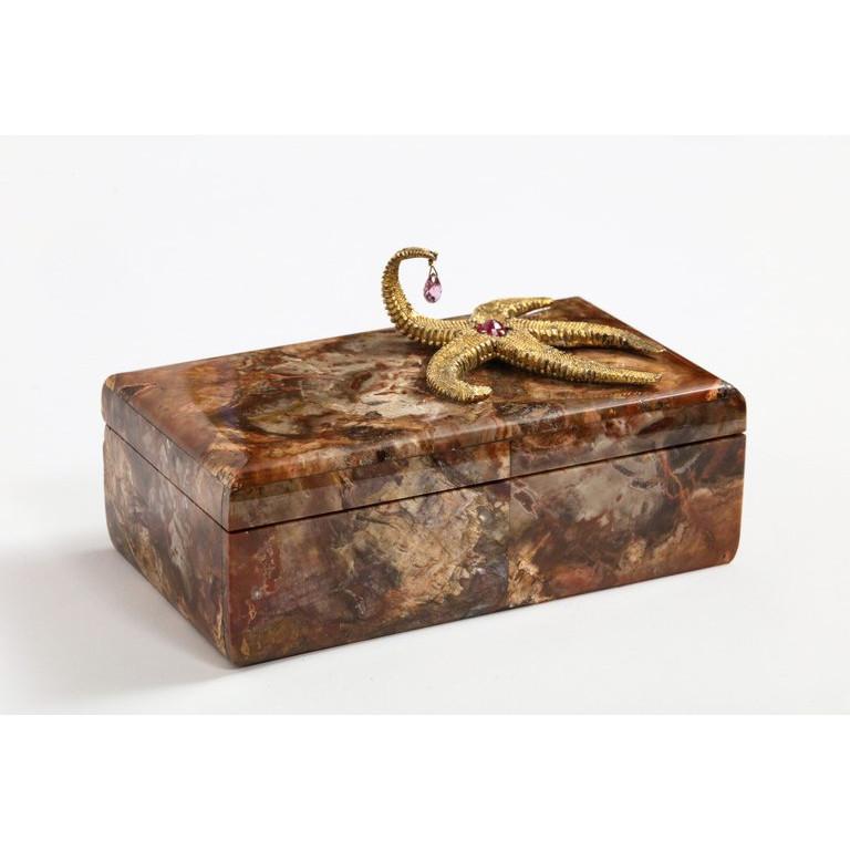 A petrified wood box with silver-gilt starfish and pink sapphire by Nardi, Venice, Italy, 20th century.  Comprised of finely polished petrified wood chosen for their exceptional color and patterns, the lid mounted with a large silver gilt starfish