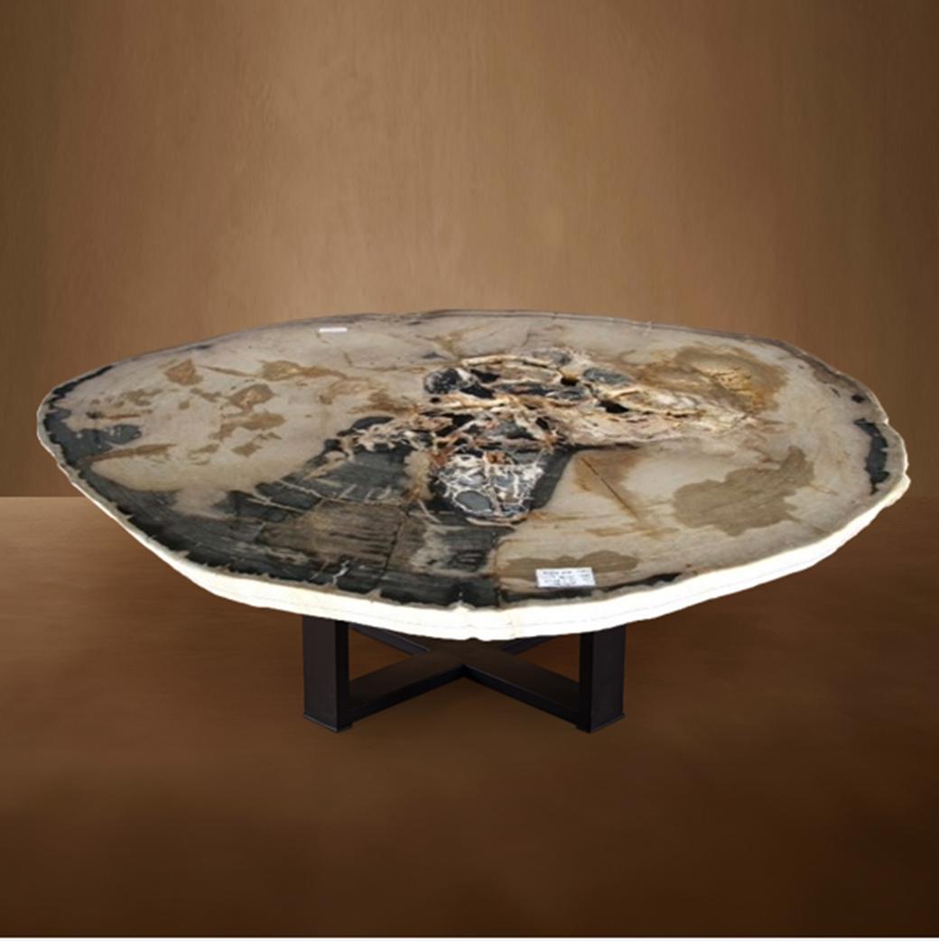 This exquisite center table is a true masterpiece, originating from Indonesia, with a slab of wood that dates back 20 million years to the Miocene era. The slab features its original natural edge, adding a unique and organic touch to its design.