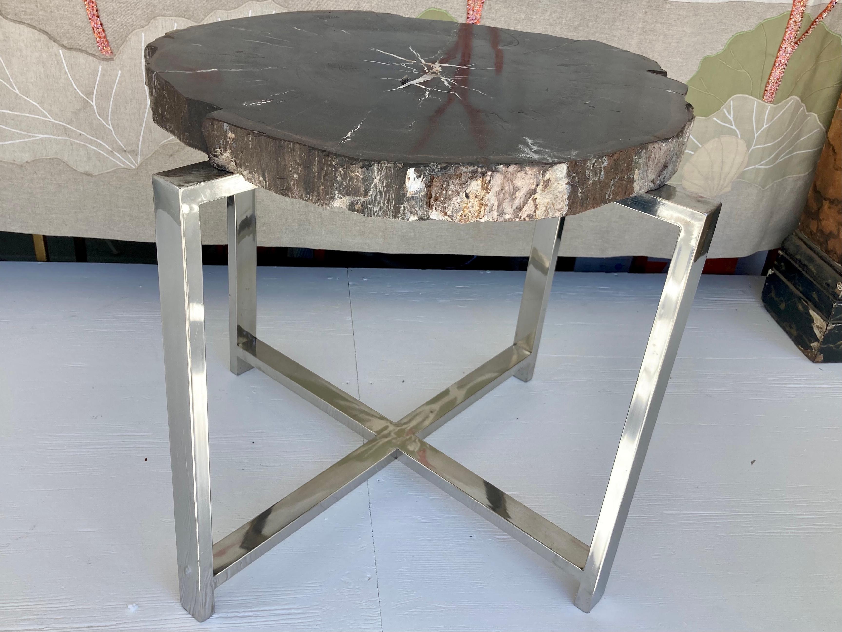Petrified wood stone table top with custom made 4 leg chrome base. Very modern looking with gorgeous character top. Very heavy with solid chrome base. Add some history and character to your home.