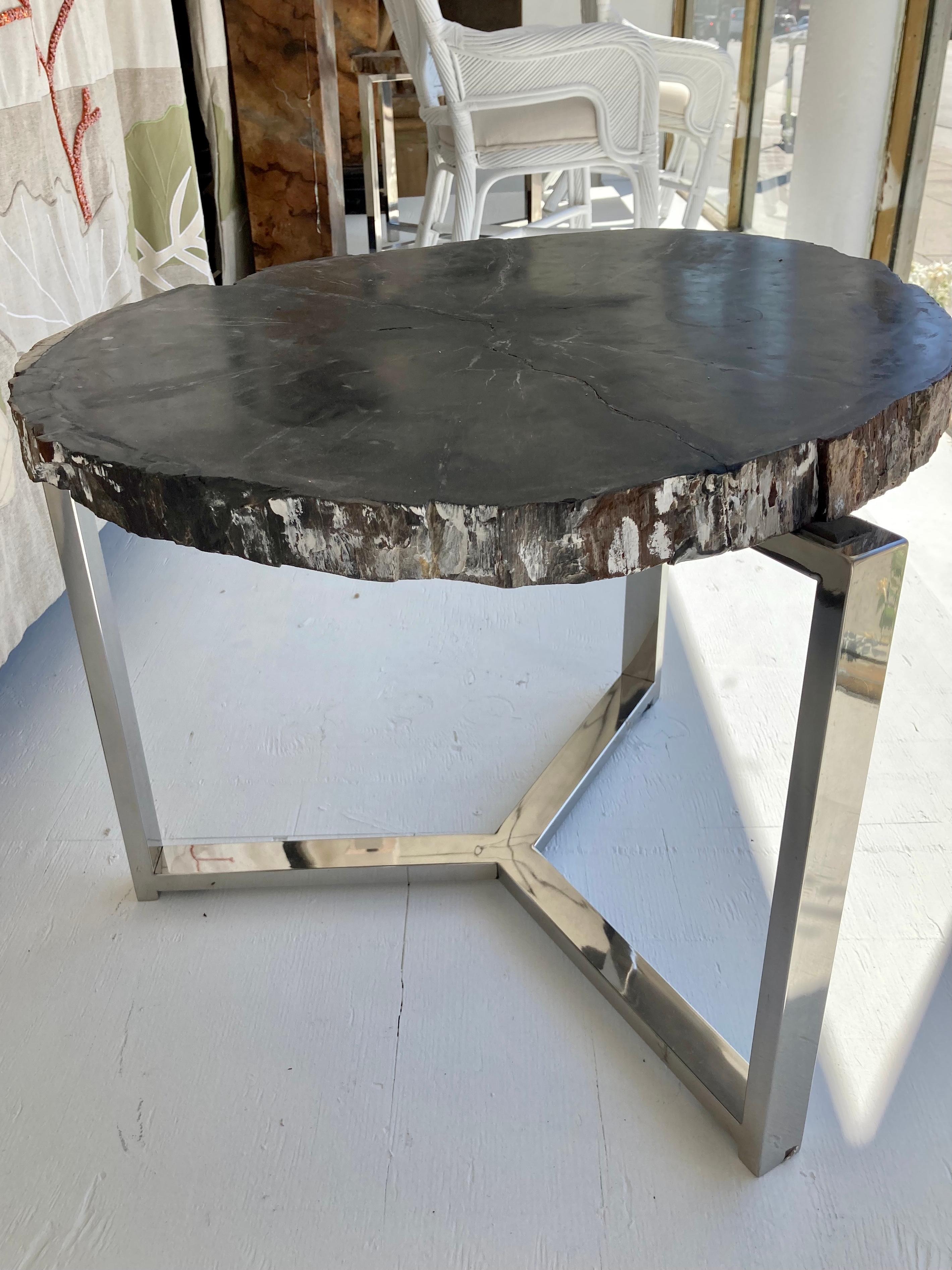 Petrified wood stone table top with custom made 3 leg chrome base. Very modern looking with gorgeous character top  Very heavy with solid chrome base. Add some history and character to your home.