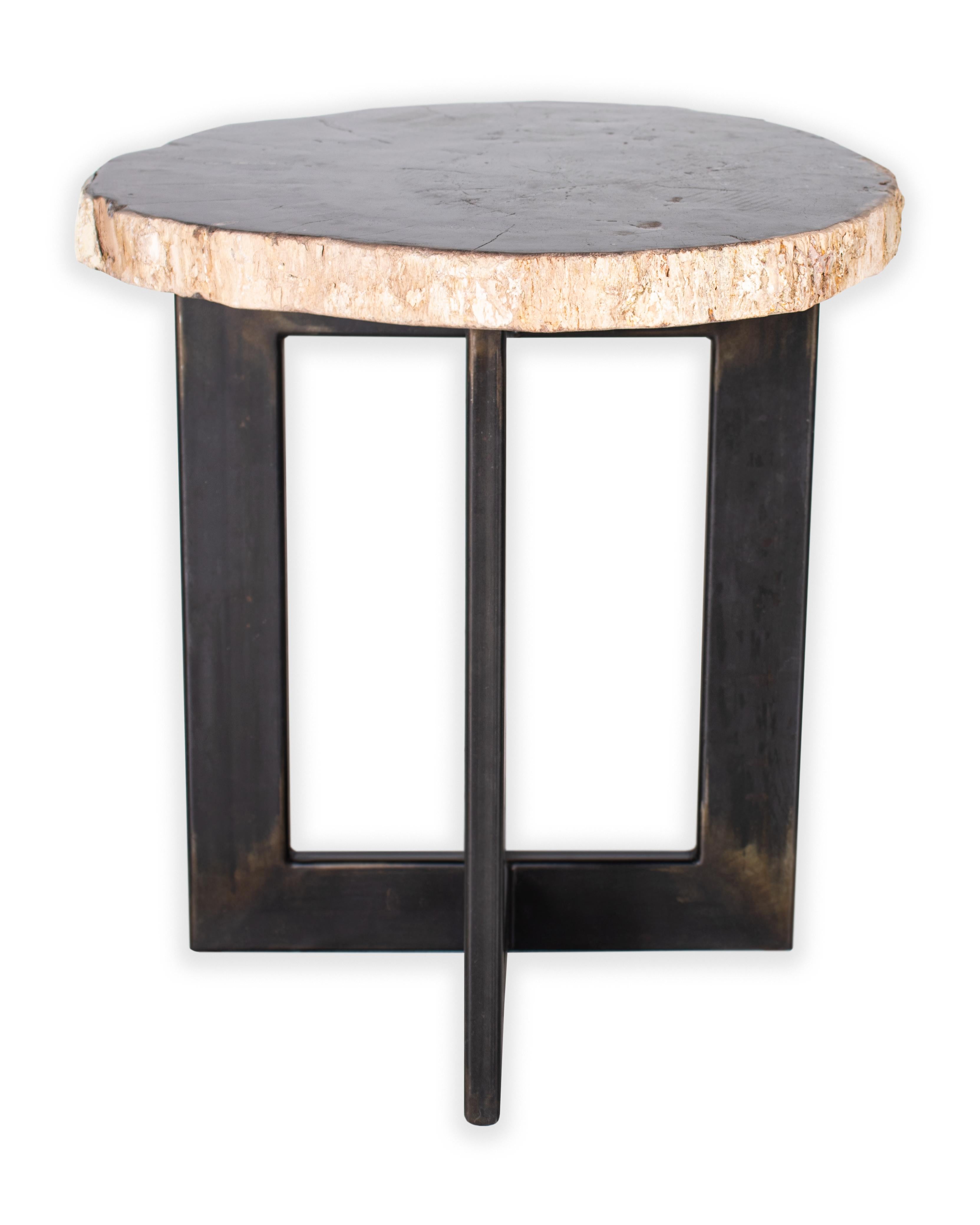 Petrified wood slice table on cross iron base. 

Piece from our one of a kind collection, Le Monde. Exclusive to Brendan Bass.